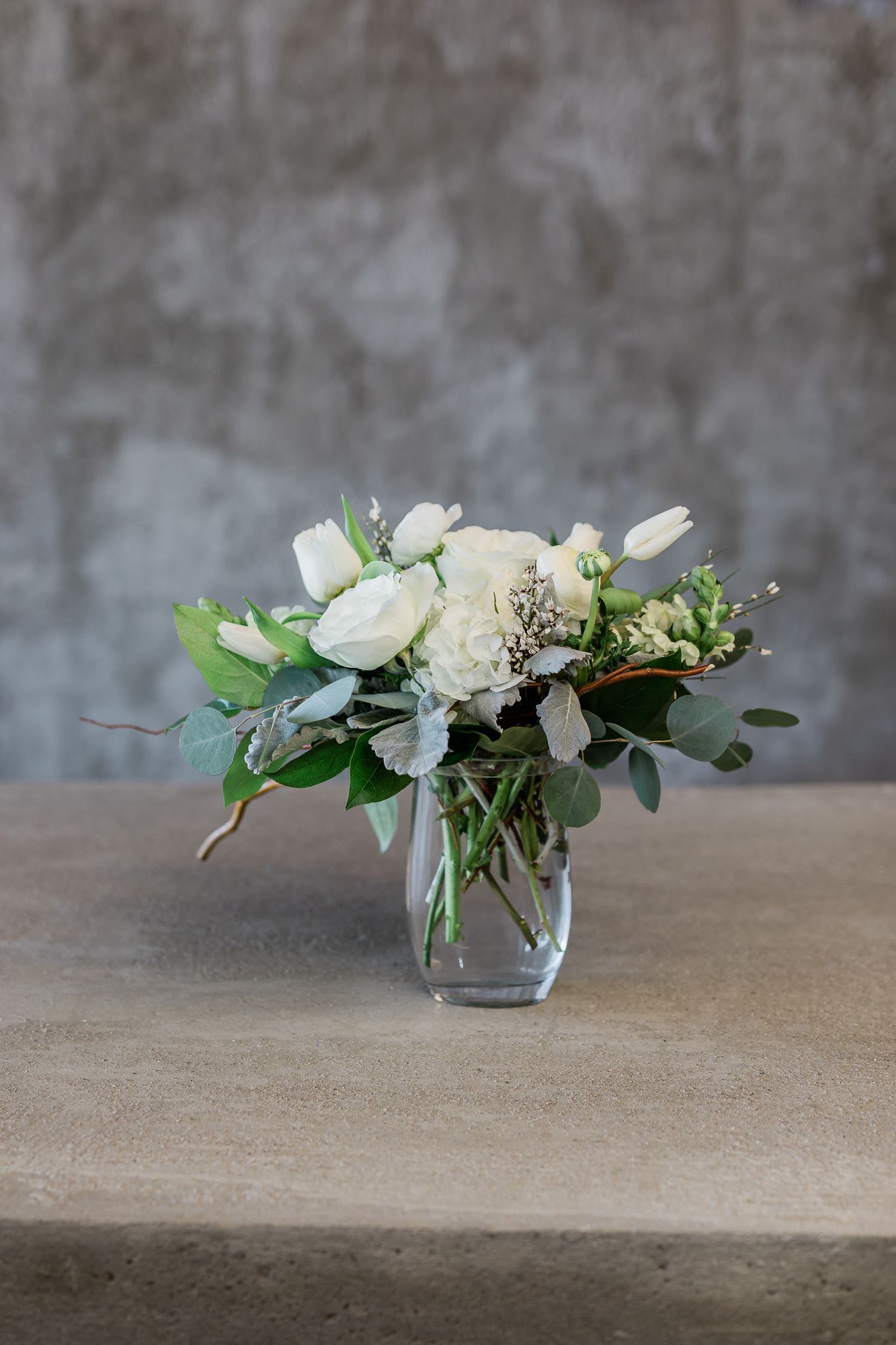 White floral arrangement in a clear glass vase