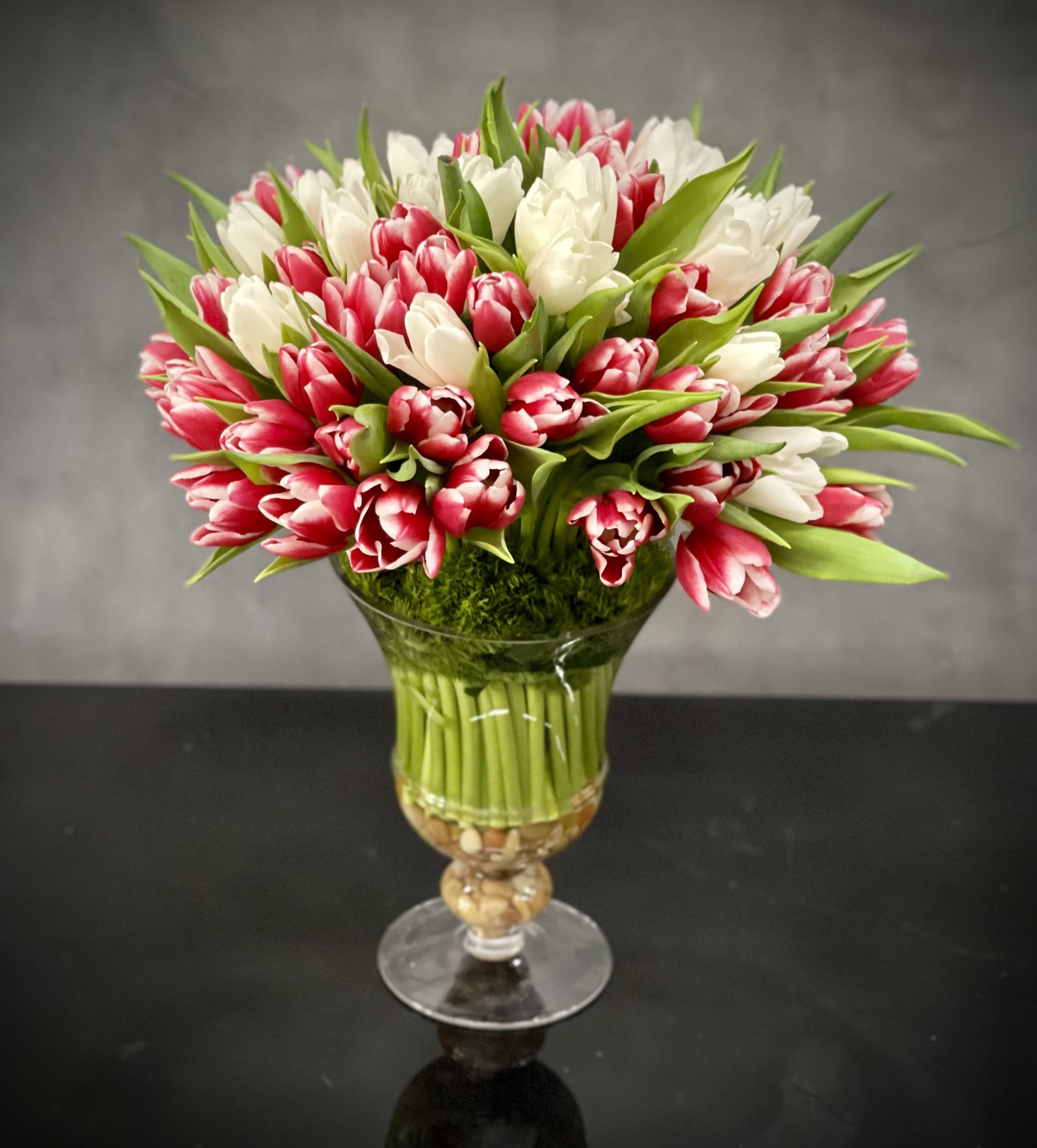Bouquet of pink and white tulips in a glass vase