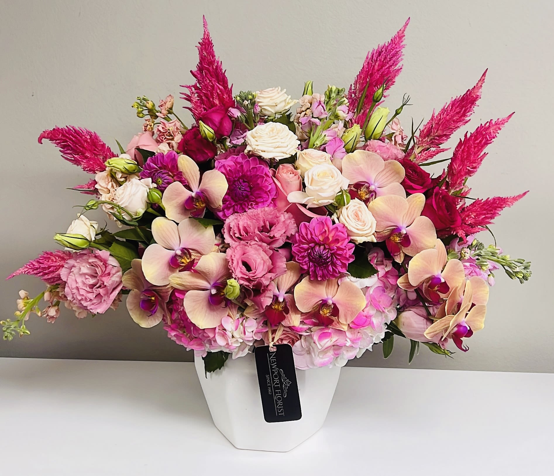 Pink and cream floral arrangement in a white vase