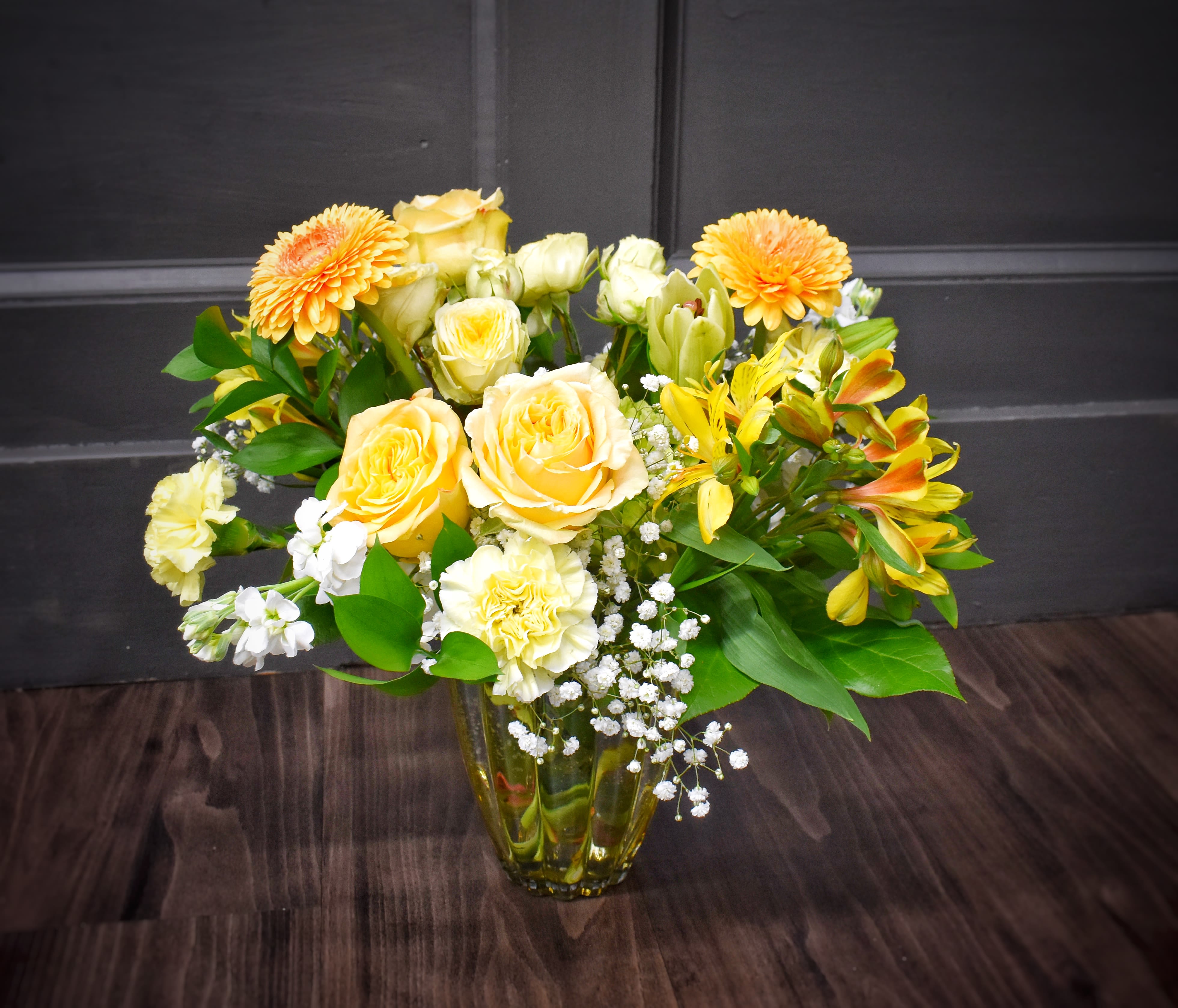 Amber Sunshine- Premium - Sunlit yellow roses and vibrant orange gerbera daisies make a bold opening line in this joyful flower arrangement - a cheerful everyday bouquet perfect for birthdays, thank-you gifts, or a bright just-because surprise. The mix of yellow-orange alstroemeria and pale carnations keeps the look lively and warm, while crisp white filler flowers and fresh greenery soften the palette so the person you're thinking of feels genuinely seen and cheered.  