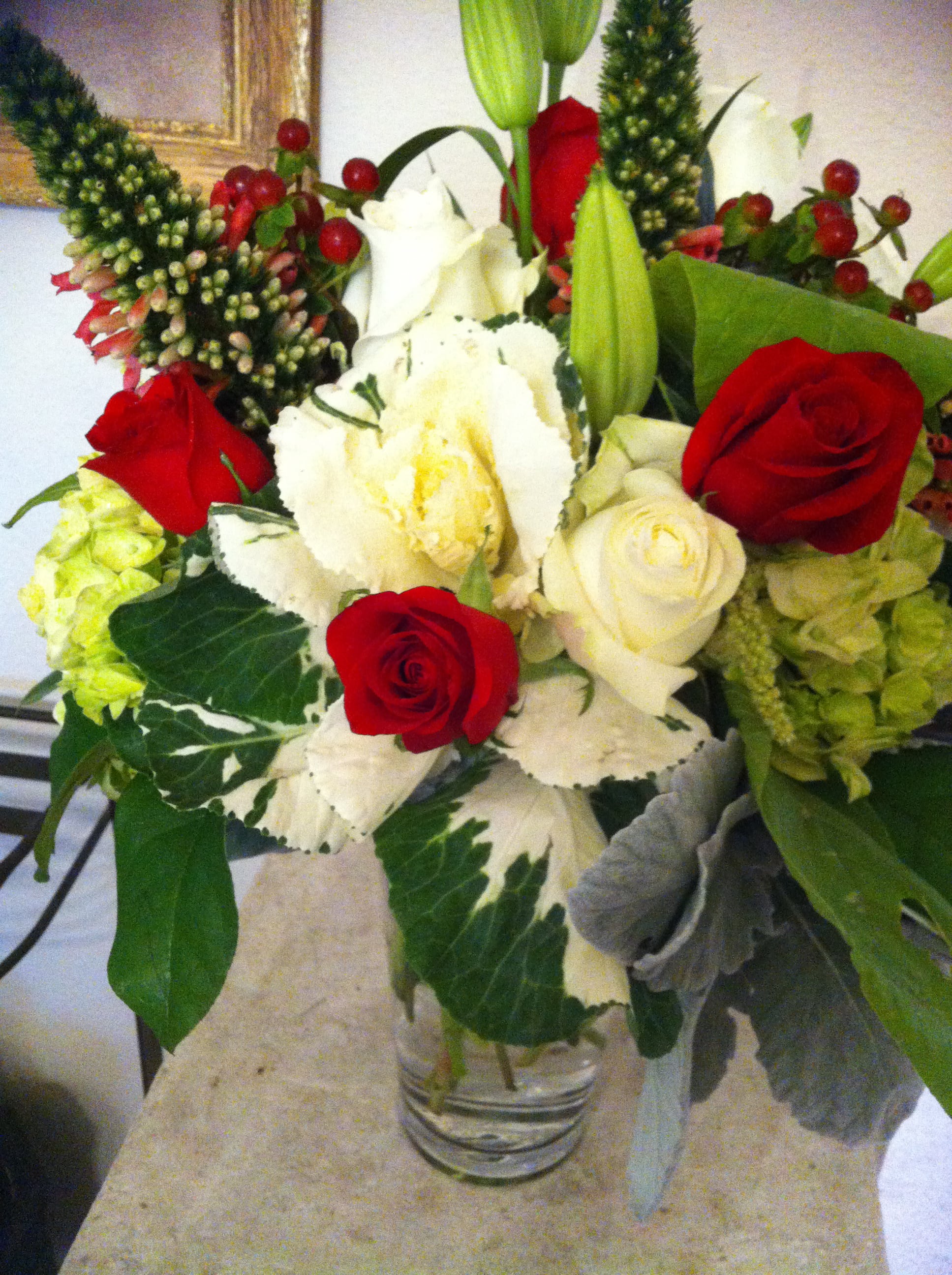 Bouquet of red and white roses in a clear glass vase