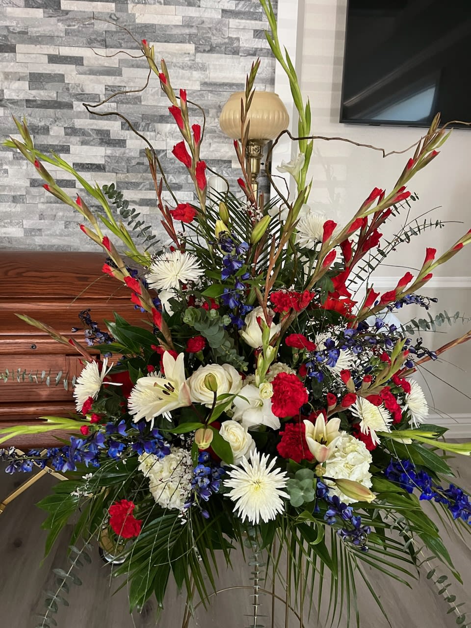 Large red, white, and blue floral arrangement in a room