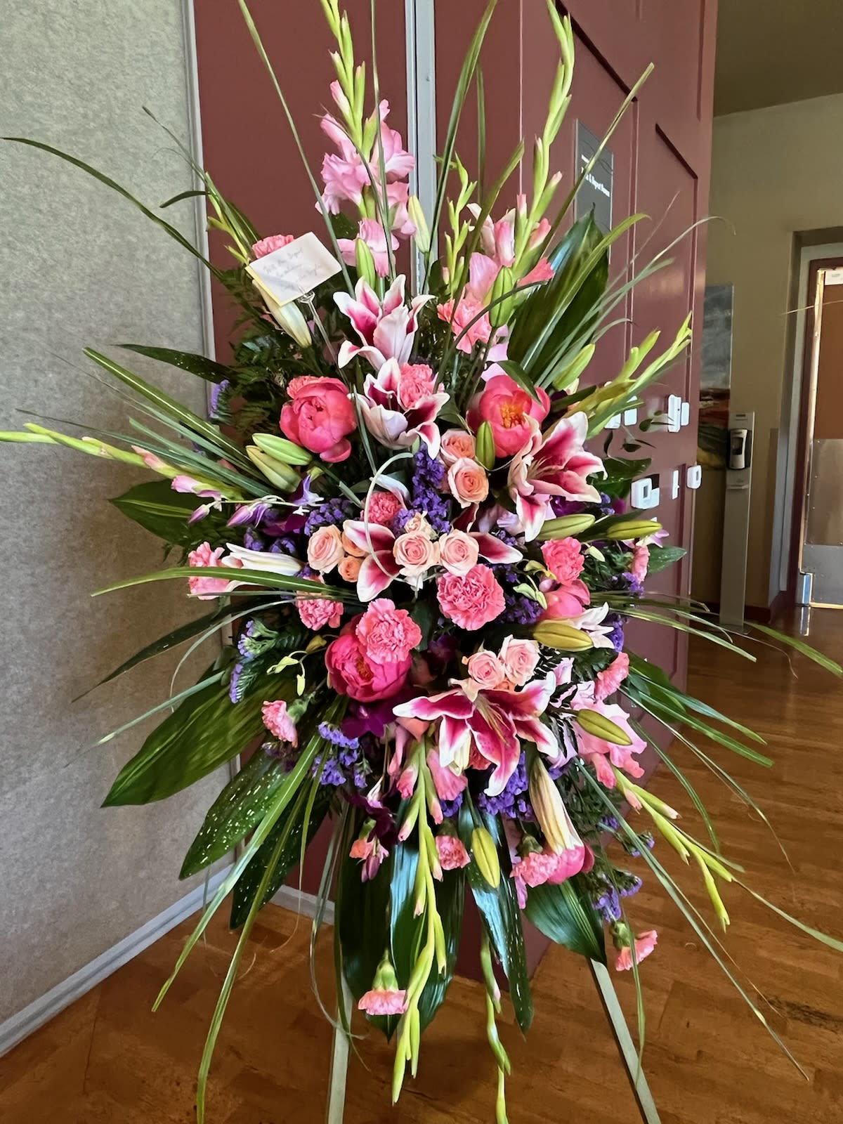 Tall pink and white floral standing arrangement with lilies and roses
