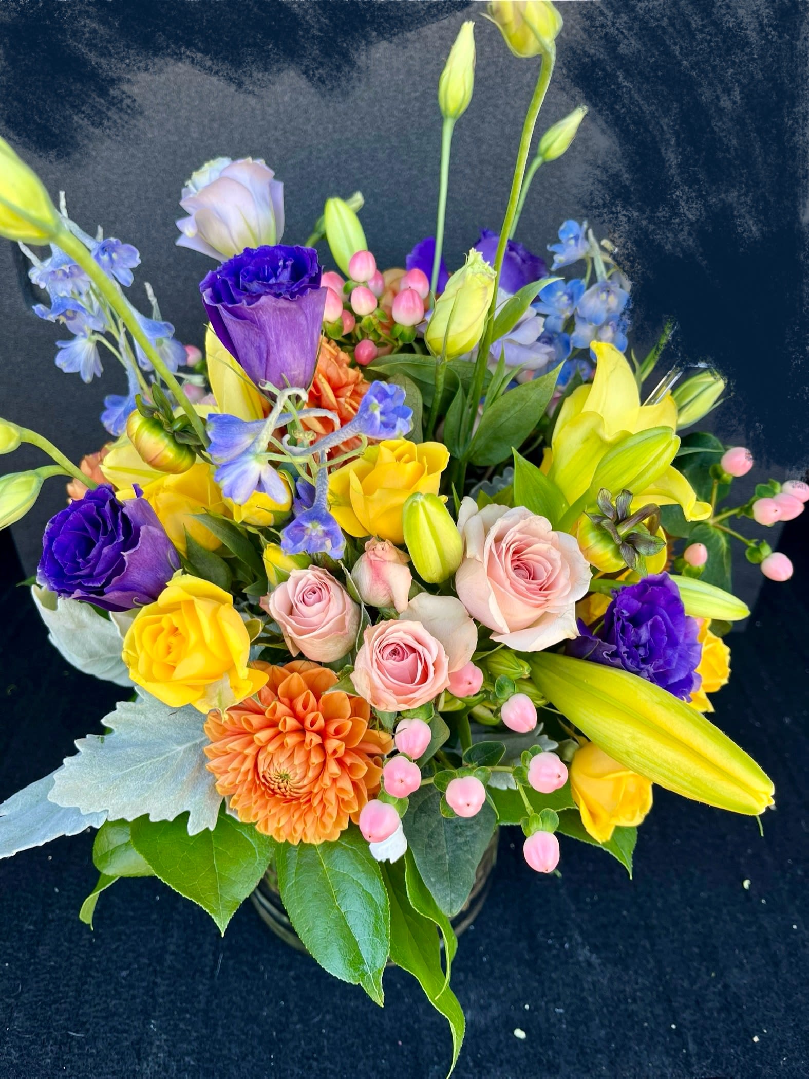 Colorful mixed bouquet with roses, lilies, and dahlias