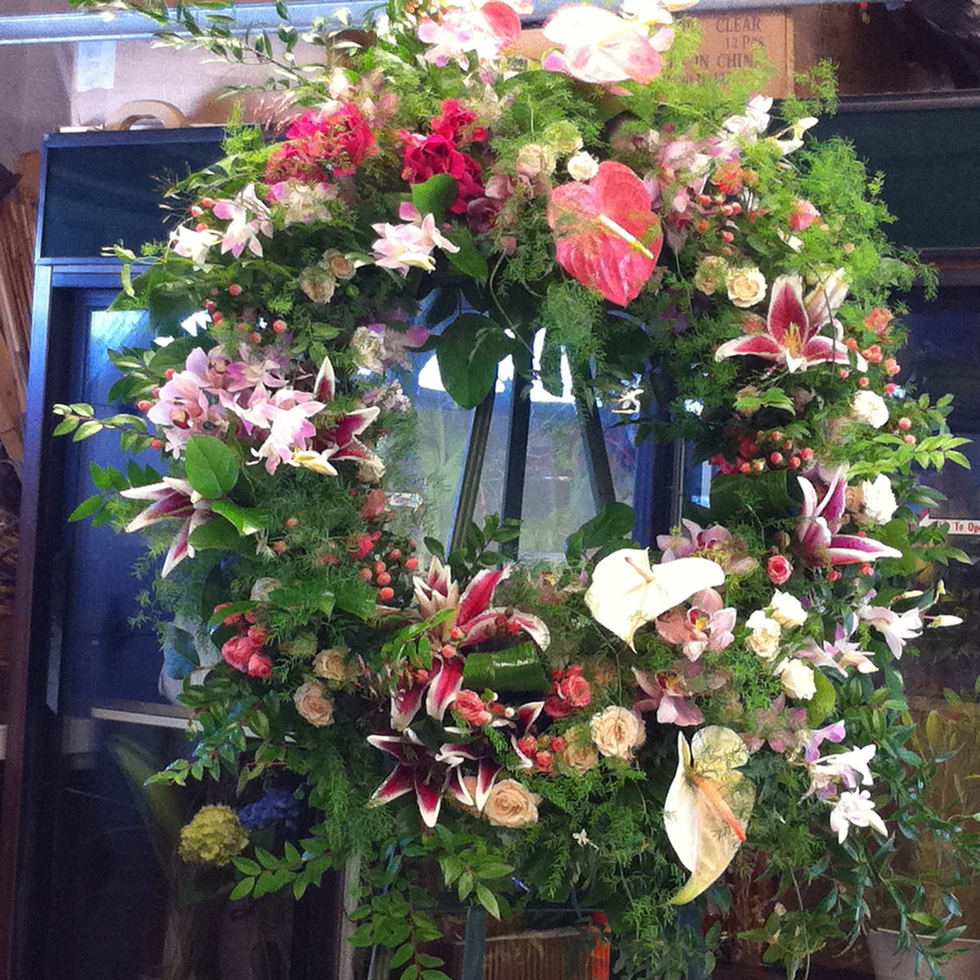 Large floral wreath with lilies, anthuriums, and roses