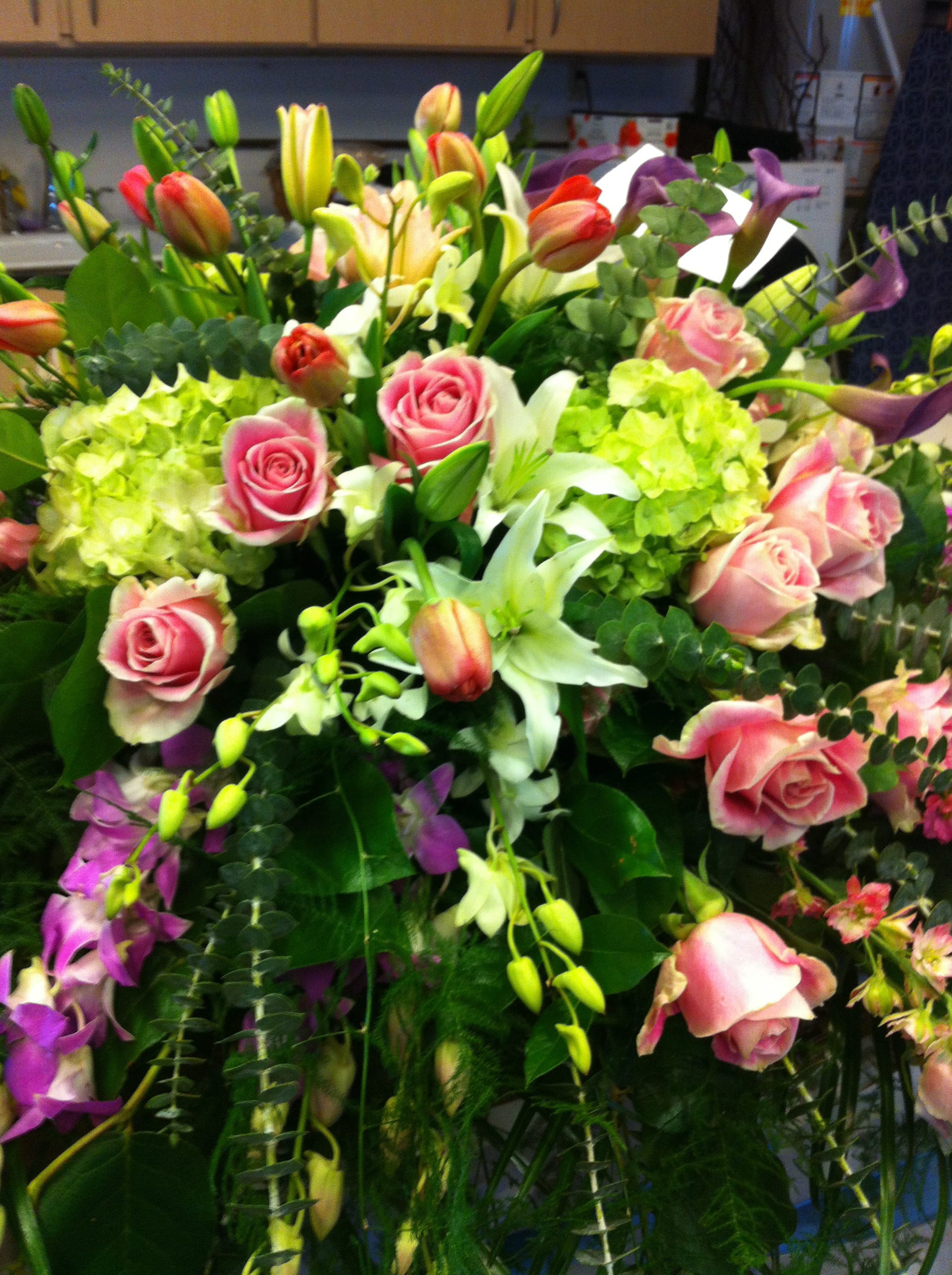 Mixed bouquet of pink roses, lilies, and purple calla lilies