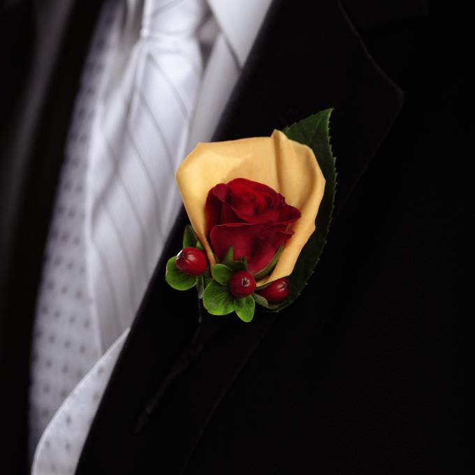 FTD Breathless Boutonniere - The FTDÂ® Breathlessâ¢ Boutonniere is full of rich color and warm beauty   to give the men in your wedding party the complete look. A single red   spray rose is accented with an orange rose petal and red hypericum   berries to bring a modern style and charm to your big day. Approx. 5âH x   2âW.   
