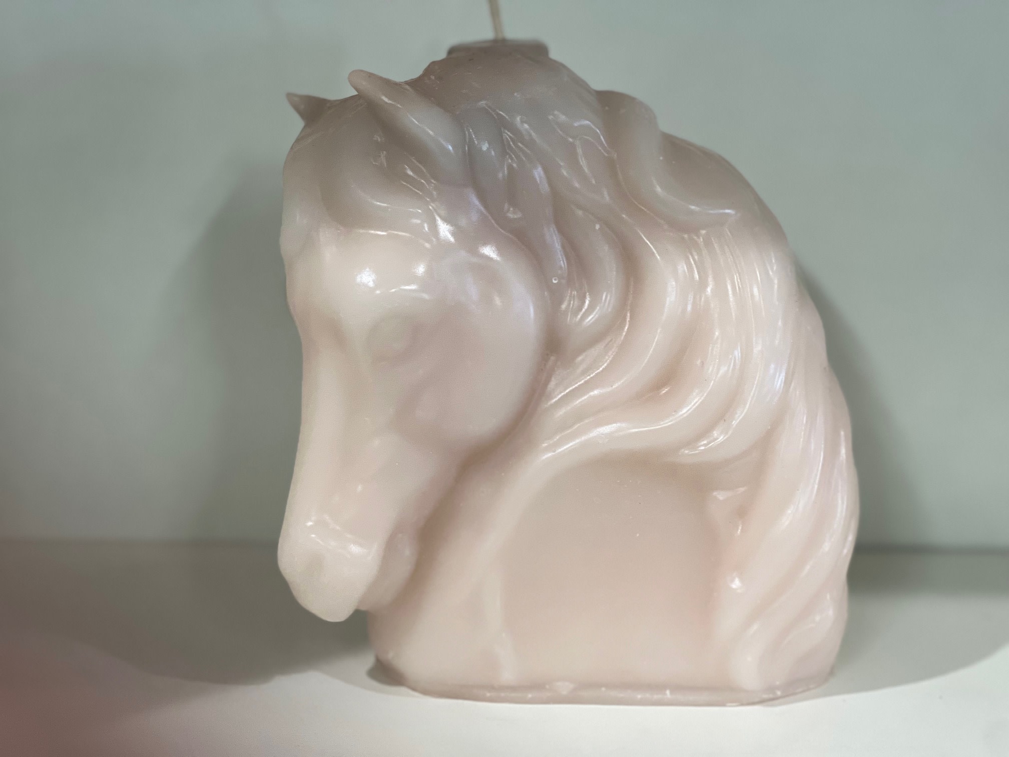 Glossy pale pink horse head figurine
