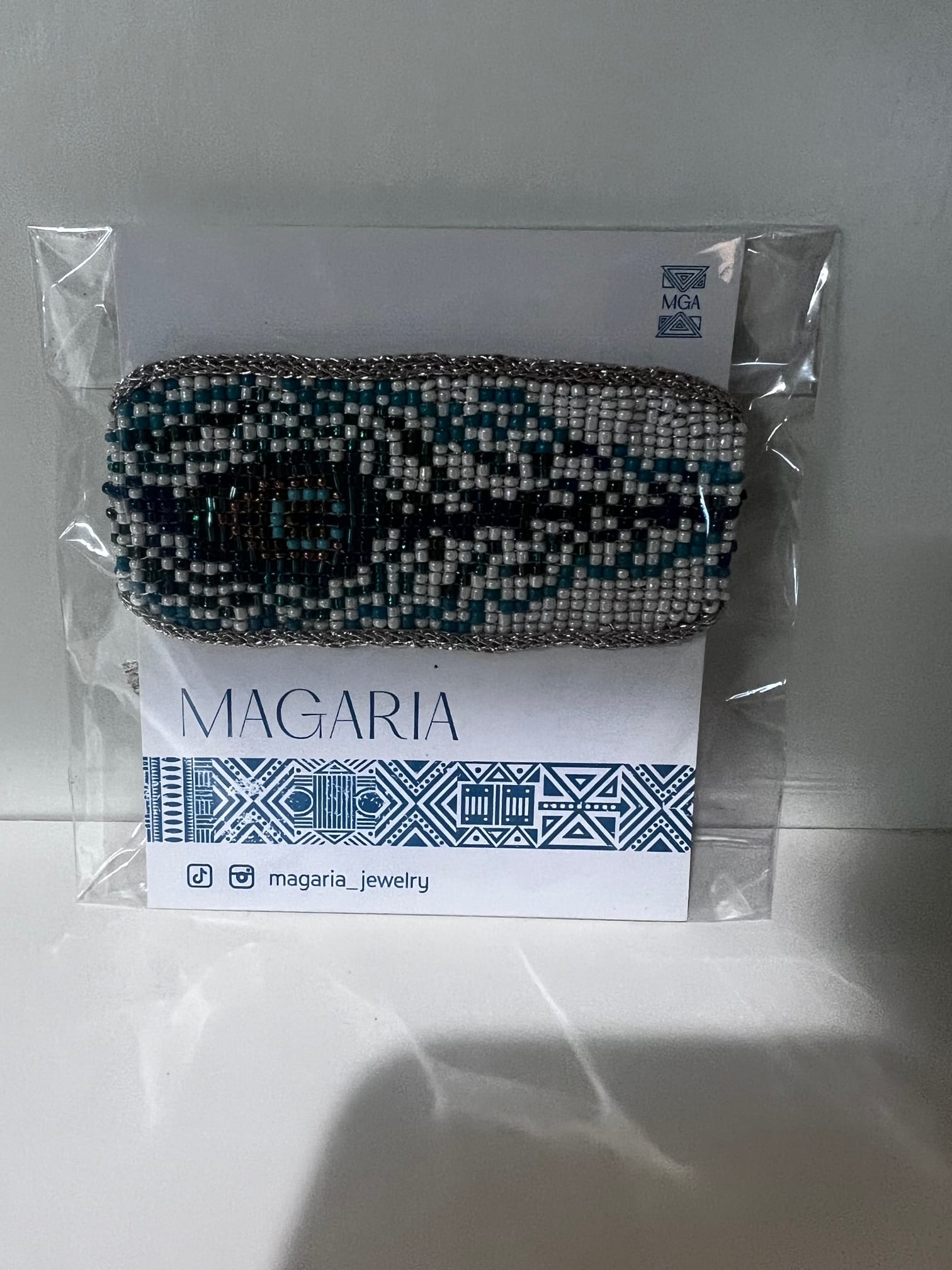 Beaded bracelet on a branded card in clear plastic packaging