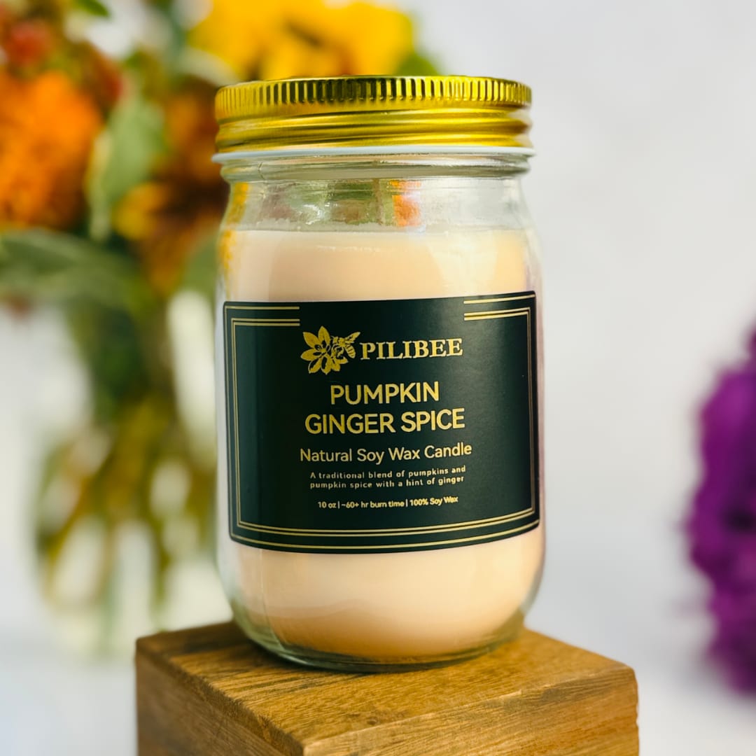 Pumpkin ginger spice candle in a glass jar with a gold lid