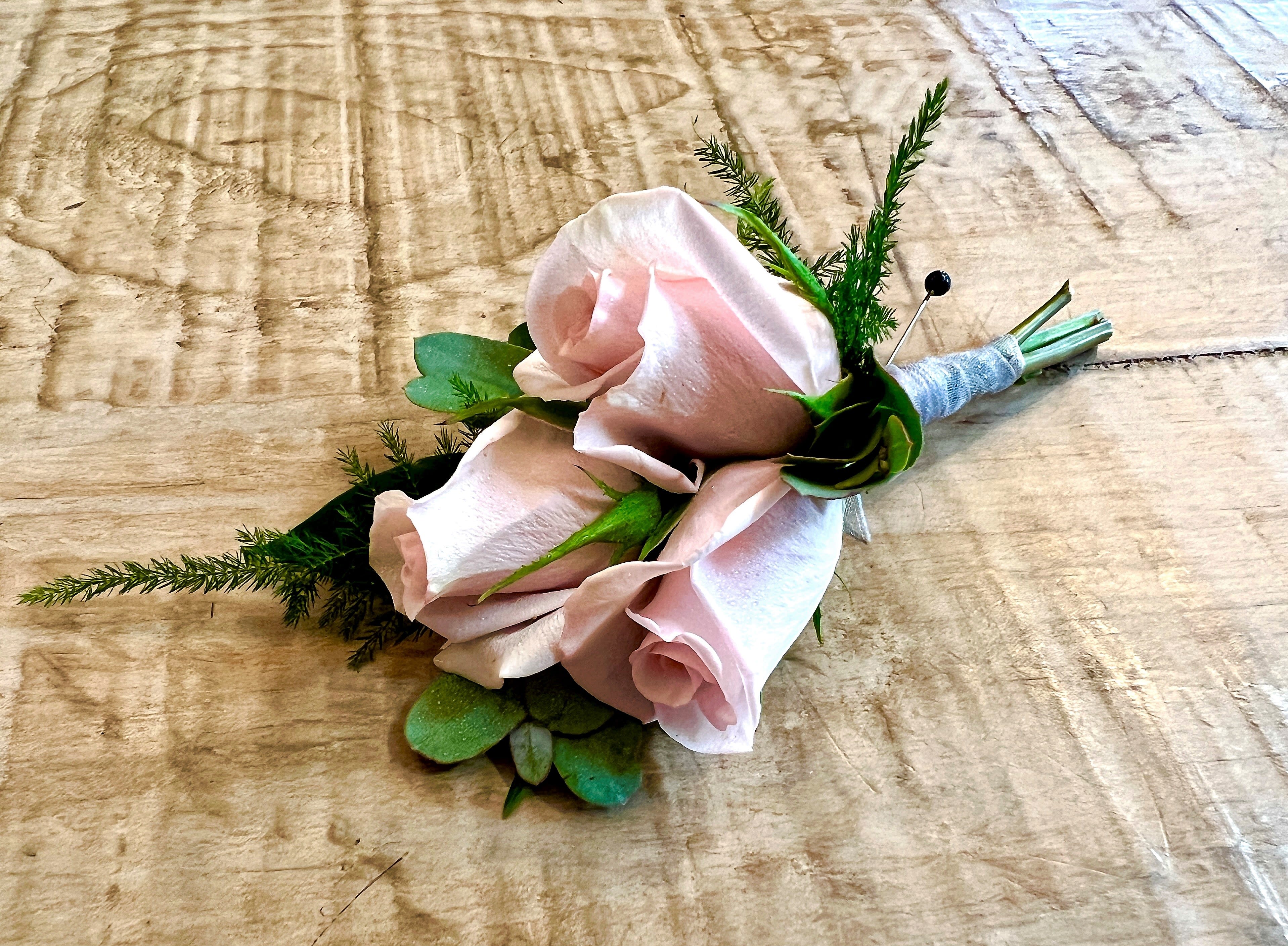 Boutonniere with pale pink roses and greenery