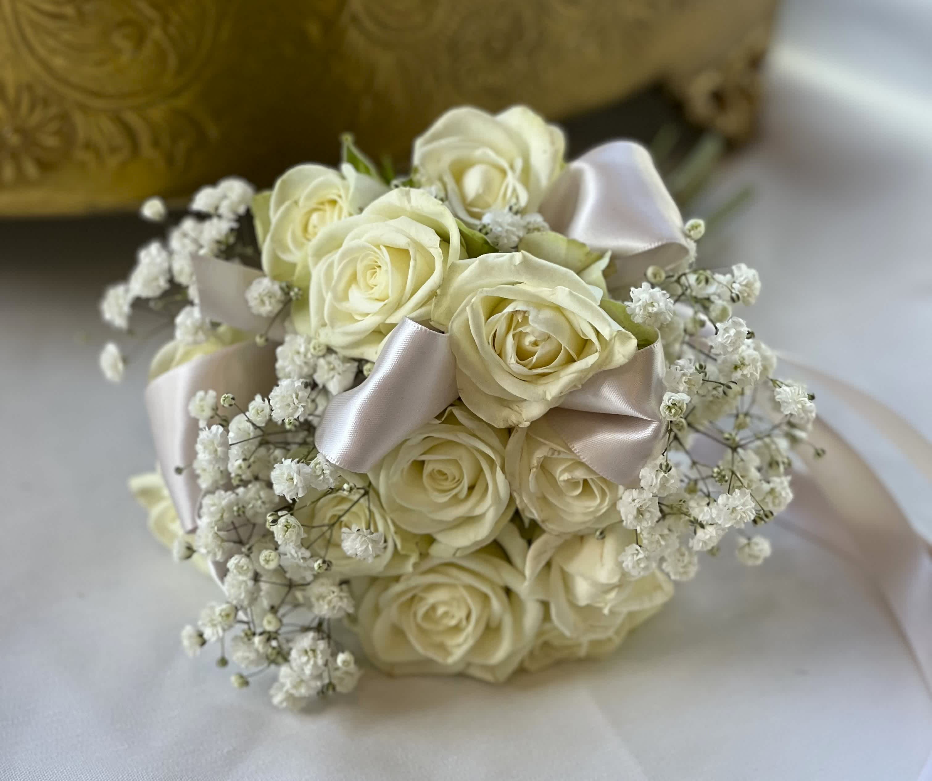Bouquet of ivory roses with baby's breath and satin ribbon