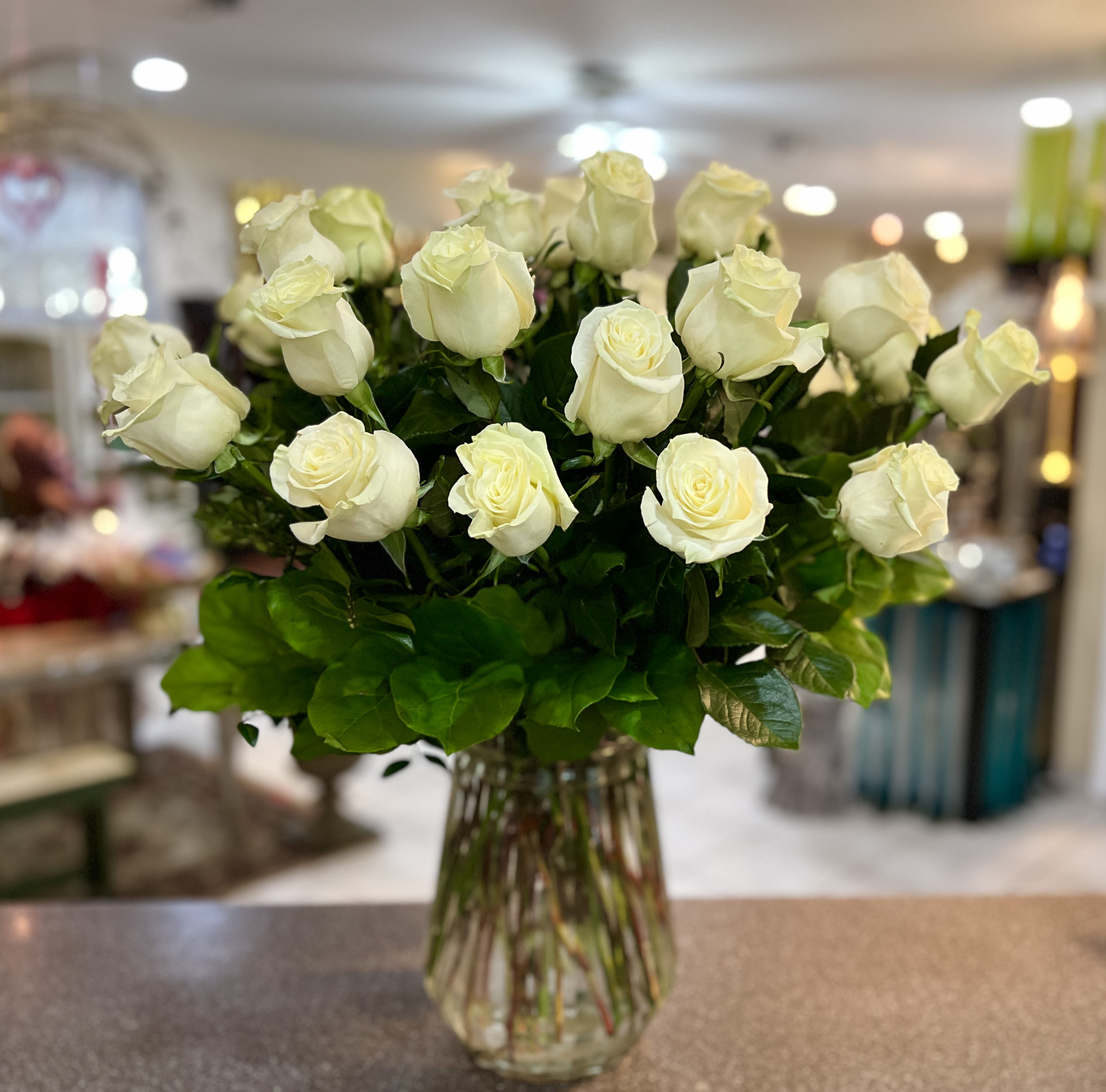 Bouquet of white roses in a clear glass vase