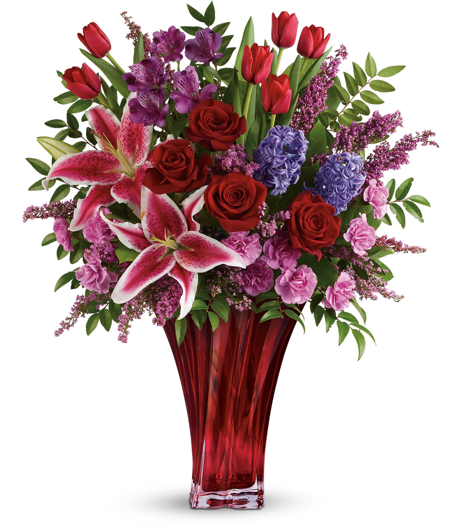 One Of A Kind Love Bouquet by Teleflora DX - For a love that's truly one of a kind. Celebrate your unique bond this Valentine's Day with this magnificent bouquet of roses, lilies, alstroemeria and more, artfully arranged in an elegant red blown-glass vase. Dazzling with graceful details, it's a true décor piece they'll enjoy forever as a resplendent reminder of your love. 
