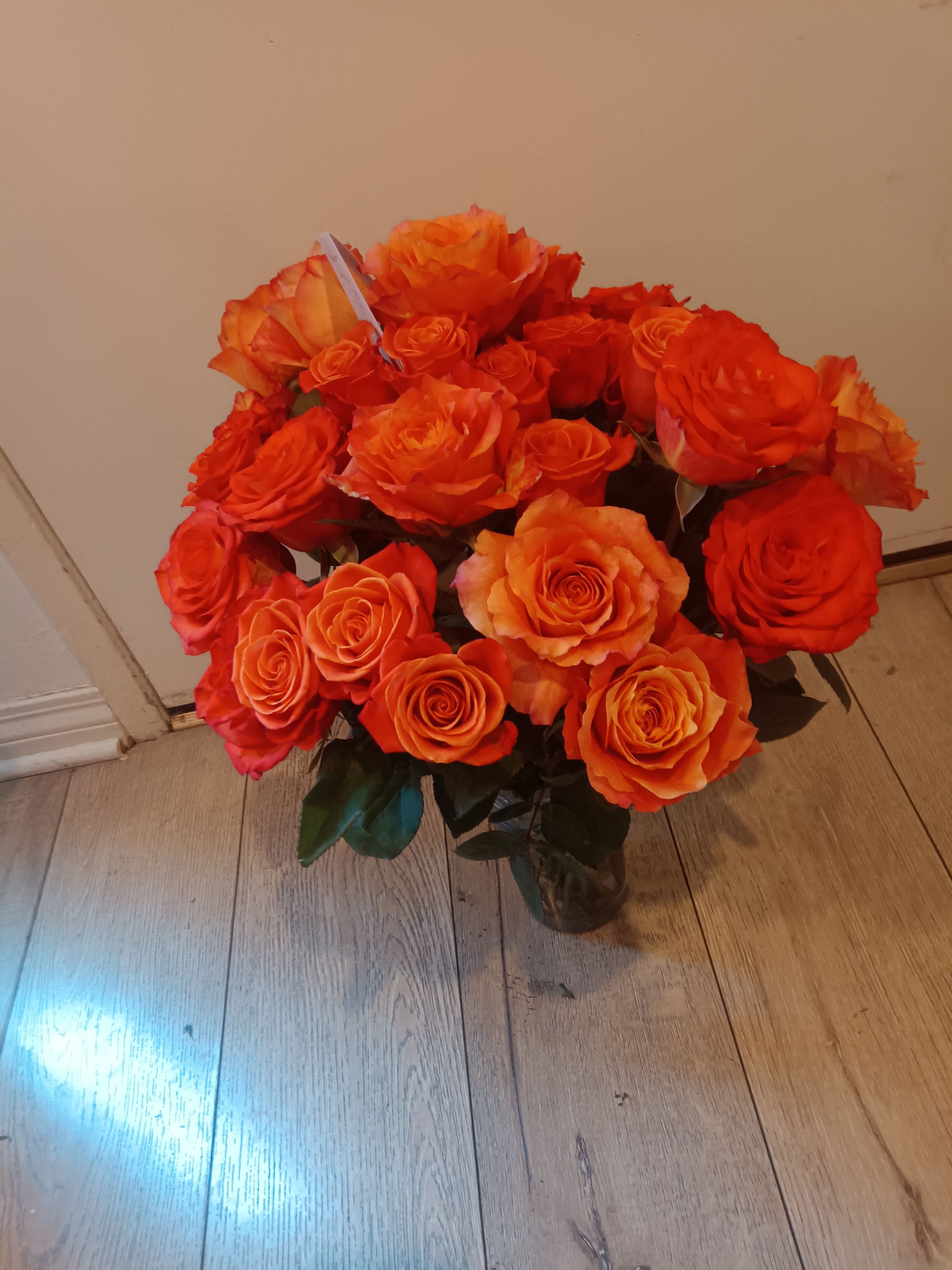 Bouquet of orange roses in a glass vase
