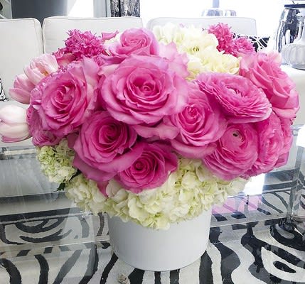 Pink and white flower arrangement in a white vase