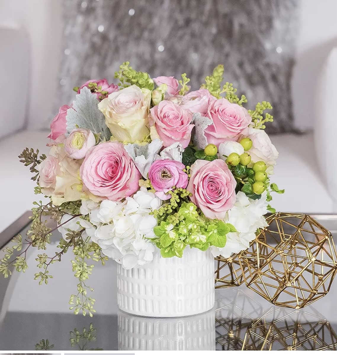 Pink and white rose bouquet in a white vase