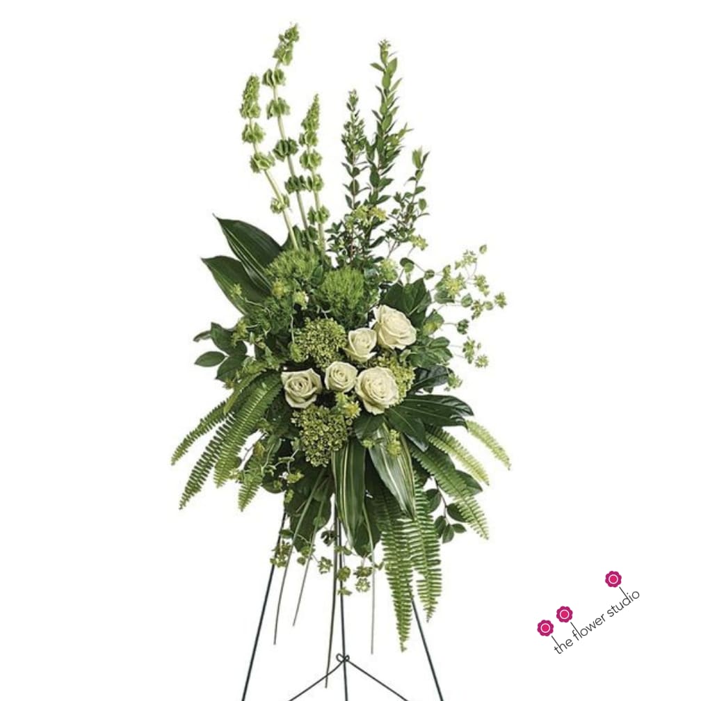 Tall white rose and greenery standing spray on an easel