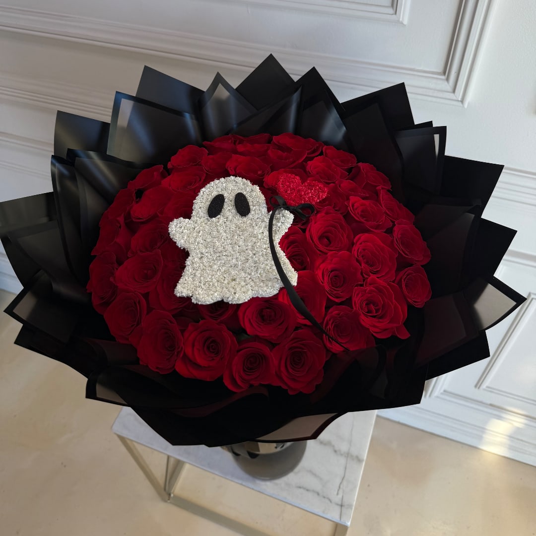 Red rose bouquet with a small ghost decoration in black wrap