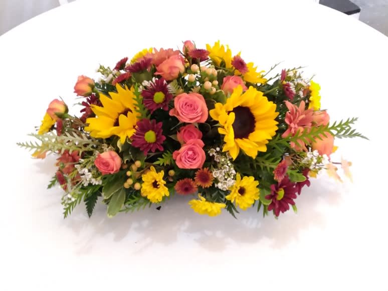 Mixed bouquet with sunflowers, pink roses, and burgundy daisies