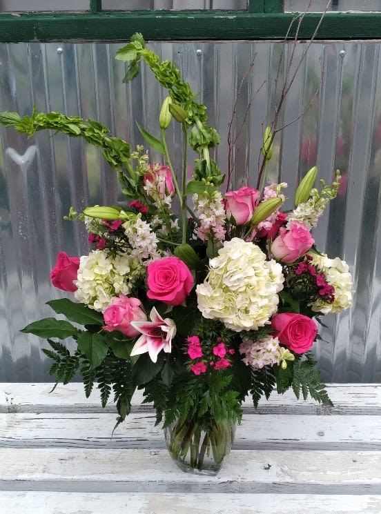 Pink and white mixed flower arrangement in a glass vase