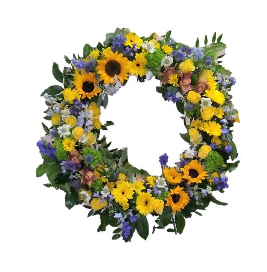 Sympathy Wreath- Sunflowers - Send your deepest sympathy with this beautiful standing spray wreath. Our design comes on an easel and will be made with love. This design features sunflowers and complementing blooms. If you would like a custom order please give us a call, or note it in the special instructions section when placing your order.  ph. 805-668-5936