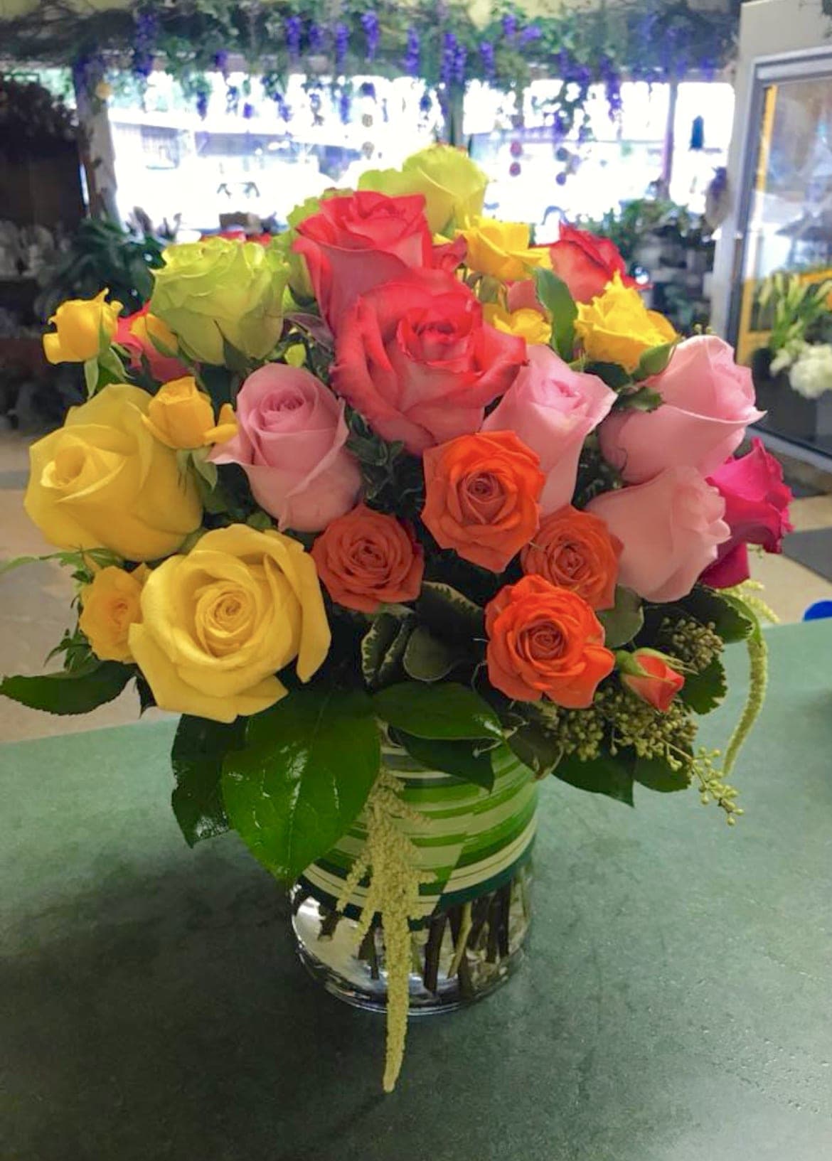 Colorful bouquet of roses in a glass vase