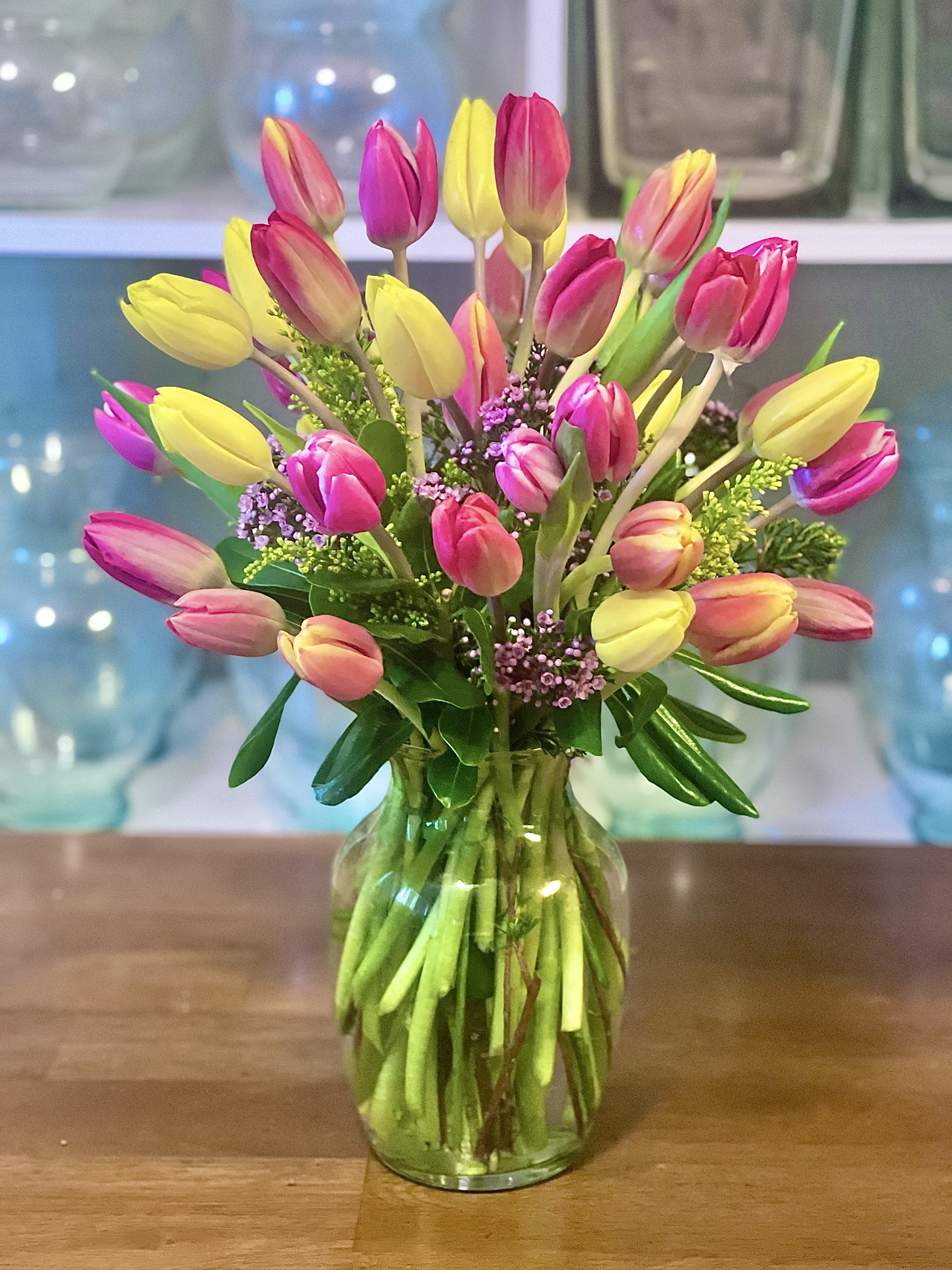 Bouquet of pink and yellow tulips in a glass vase