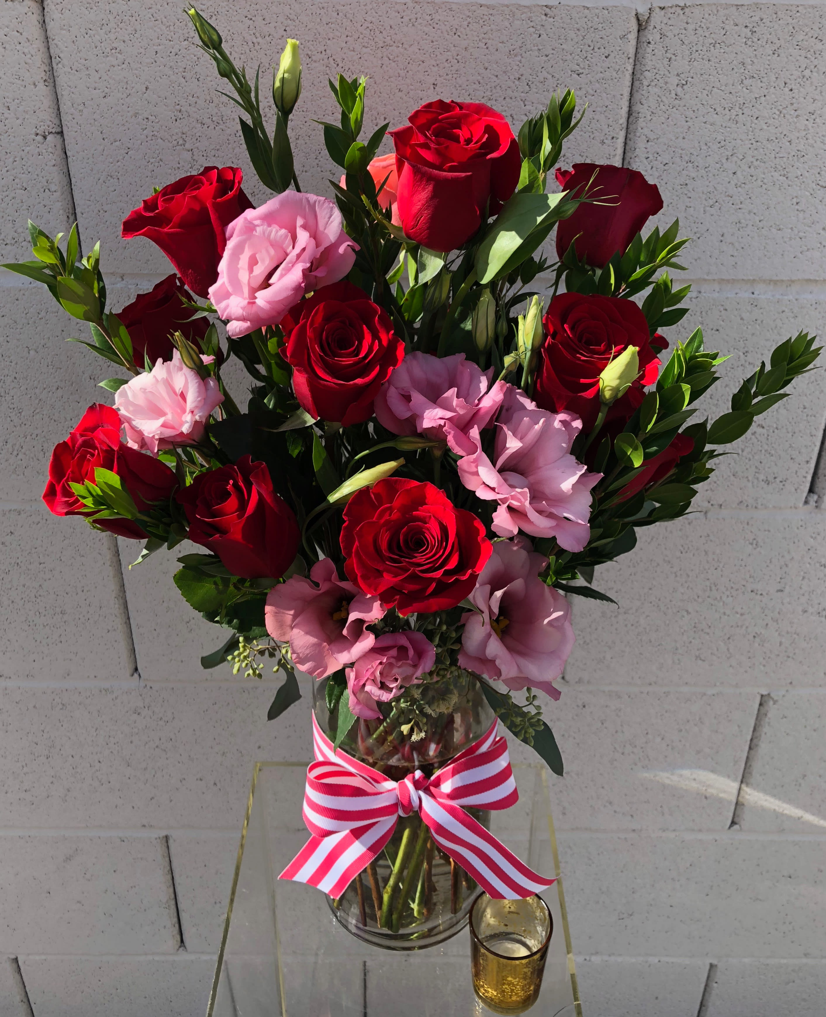 Cupid's Arrow" - This red and pink arrangement is sure to be the sweetest treat! Red roses and pink lisianthus make for a great gift arrangement perfect for any occasion. 