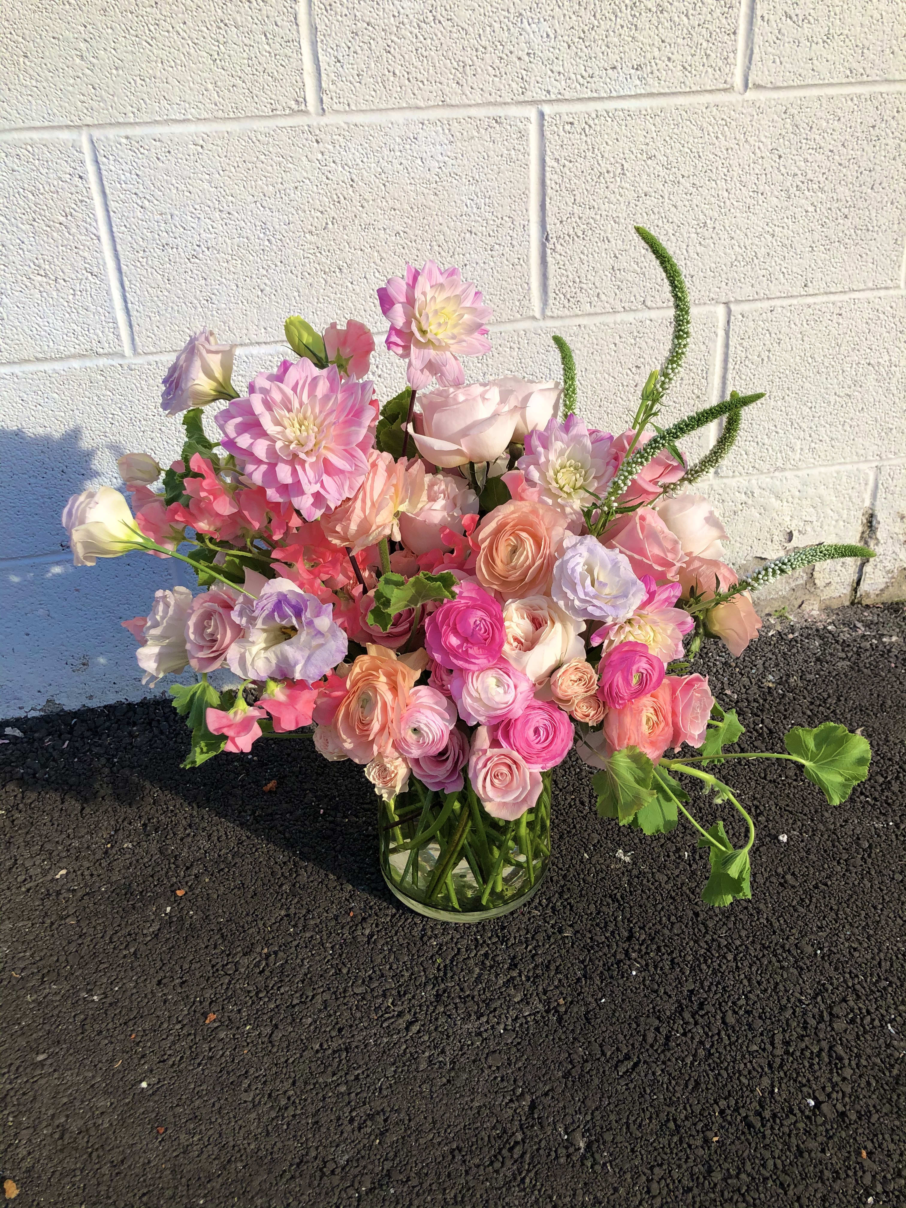 Need I Say More? - This modern garden style arrangement is lush and full of seasonal premium blooms.  Pink and peach dahlias, lisianthus, ranunculus, garden roses and sweet pea in a lush garden-style bouquet- full of fun.