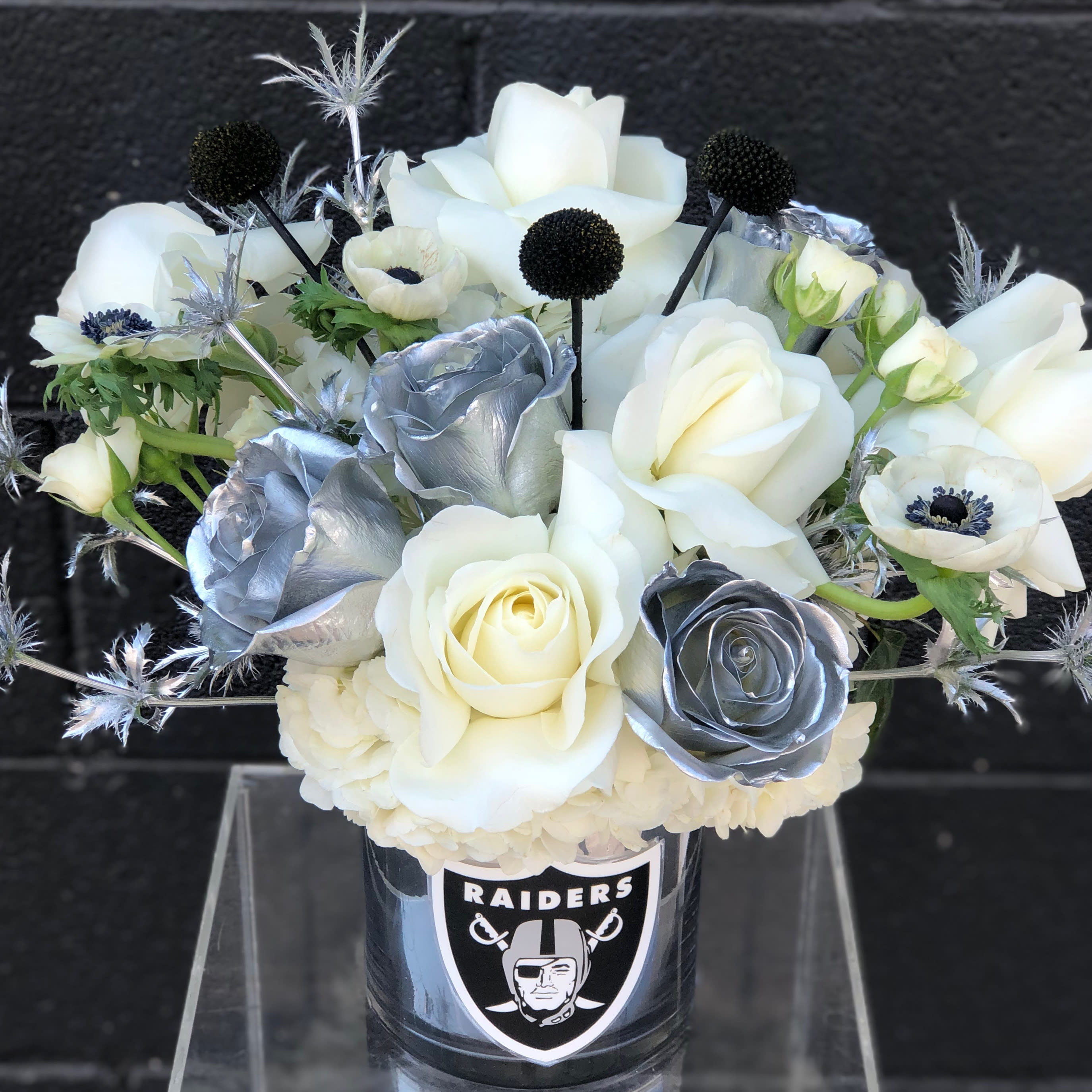 Welcome to Raider Nation - Black, silver, and white for your favorite Las Vegas sports team! A great way to show your team spirit with a fresh floral arrangement. 