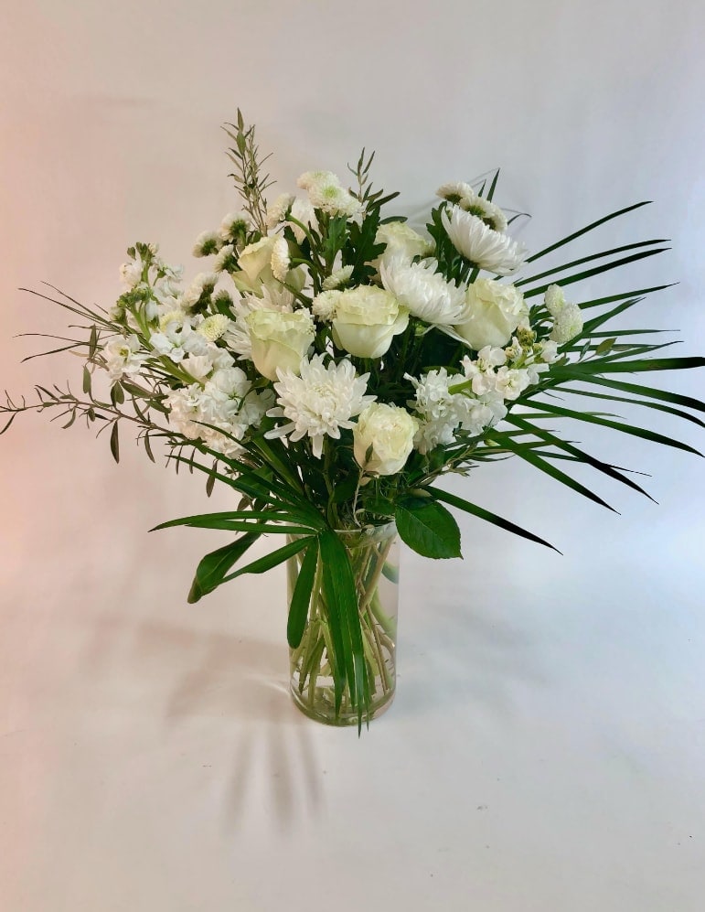 White floral arrangement in a clear glass vase