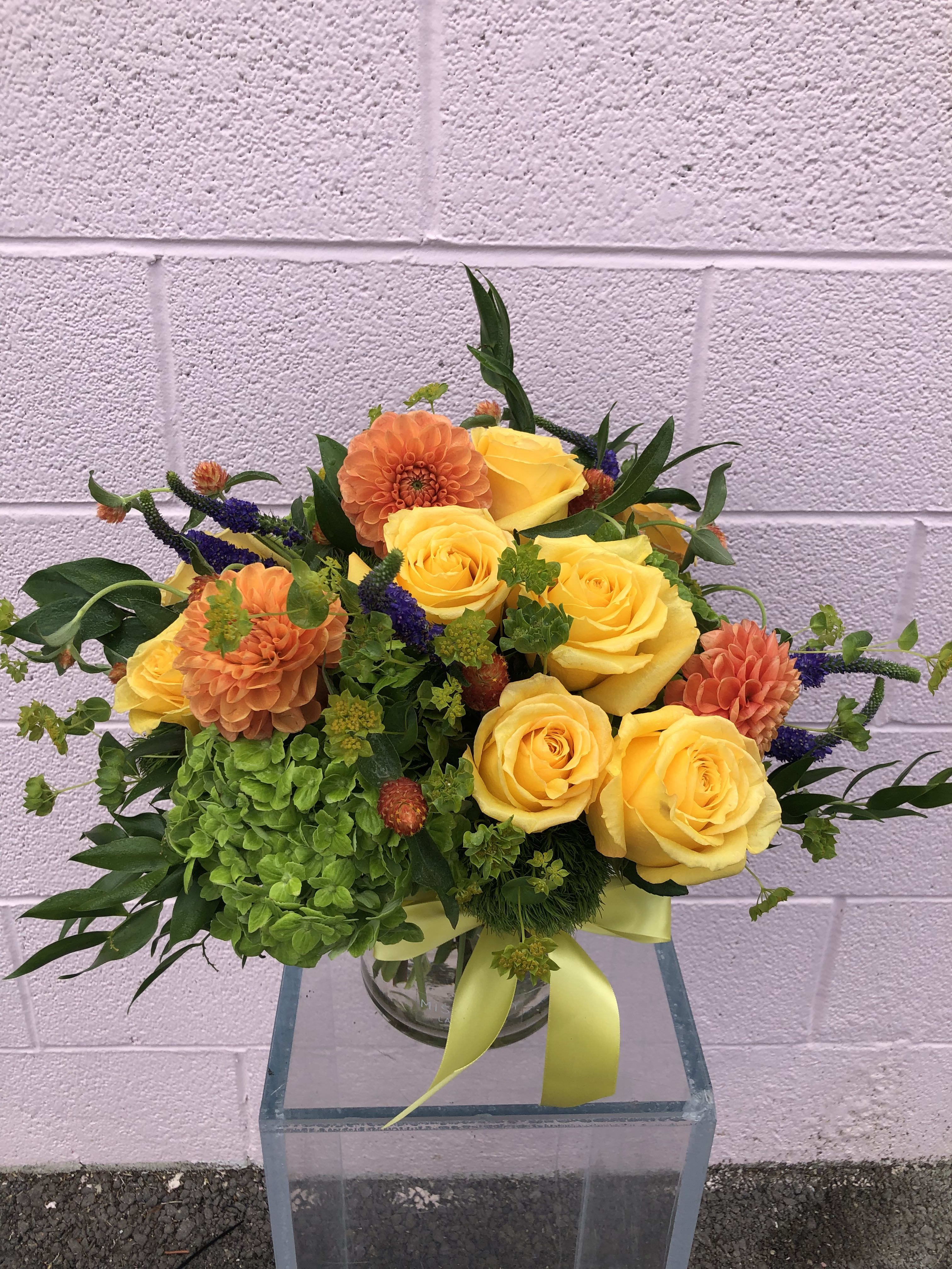 Sunny Afternoon - Bring the sunshine inside with this bright and cheery arrangement! This arrangement may include roses, hydrangea, veronica, and other beautifully toned elements!  *It's possible that some days we may not have the exact flowers depending on the season, or exact container specified on the arrangement's description. When this is the case, our bouquets are made with flower substitutions or delivered in a different vase than expected by using substitutions of an equal or higher value. If you'd prefer no substitutions, please send an email or call us after placing your order. Please give us at least three days notice if you're looking for an arrangement with no substitutions.Wanting a tropical getaway? Are you stuck at your desk or stuck at home? Deliver paradise directly to your space. This vibrant, tropical, designer's choice arrangement is sure to brighten your day!  *It's possible that some days we may not have the exact flowers depending on the season, or exact container specified on the arrangement's description. When this is the case, our bouquets are made with flower substitutions or delivered in a different vase than expected by using substitutions of an equal or higher value. If you'd prefer no substitutions, please send an email or call us after placing your order. Please give us at least three days notice if you're looking for an arrangement with no substitutions.