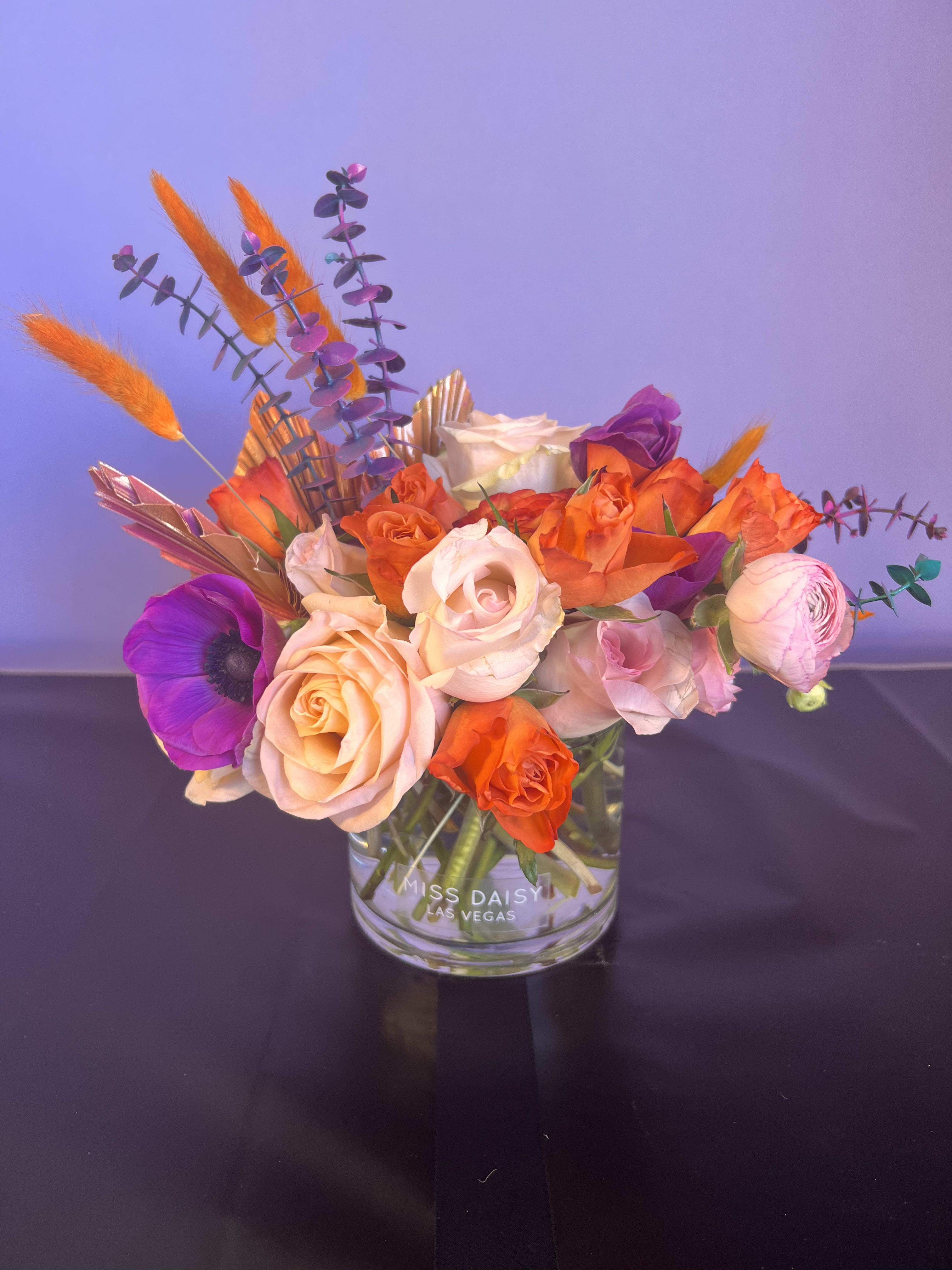Neon Lights - This low and lush designer's choice arrangement feature some neon tinted elements and is hand crafted in Las Vegas by our design team using the freshest high end florals from around the world. Our arrangements are created with love and delivered with care for you!