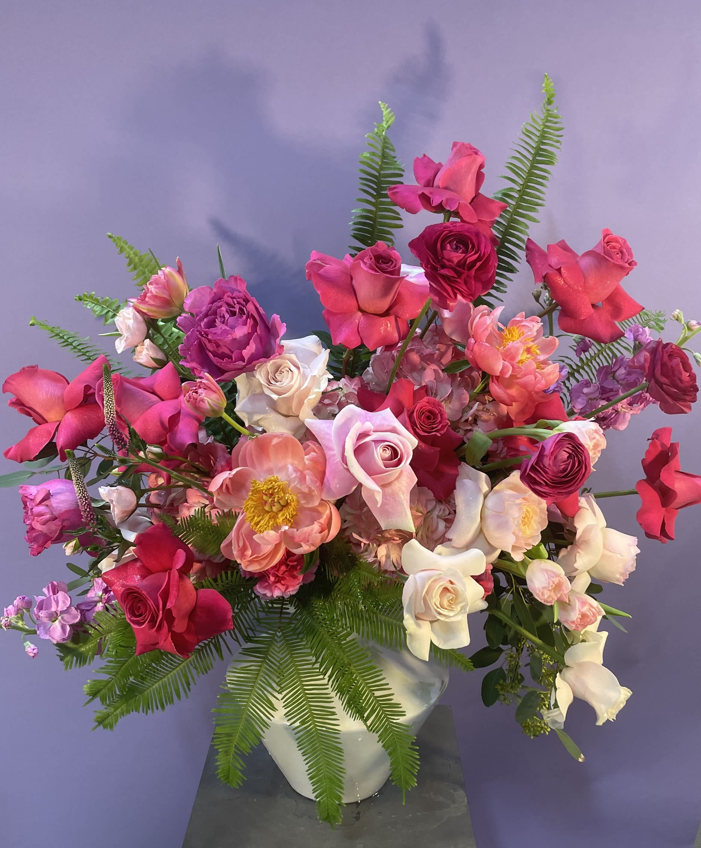 Pink and white mixed flower arrangement in a white vase