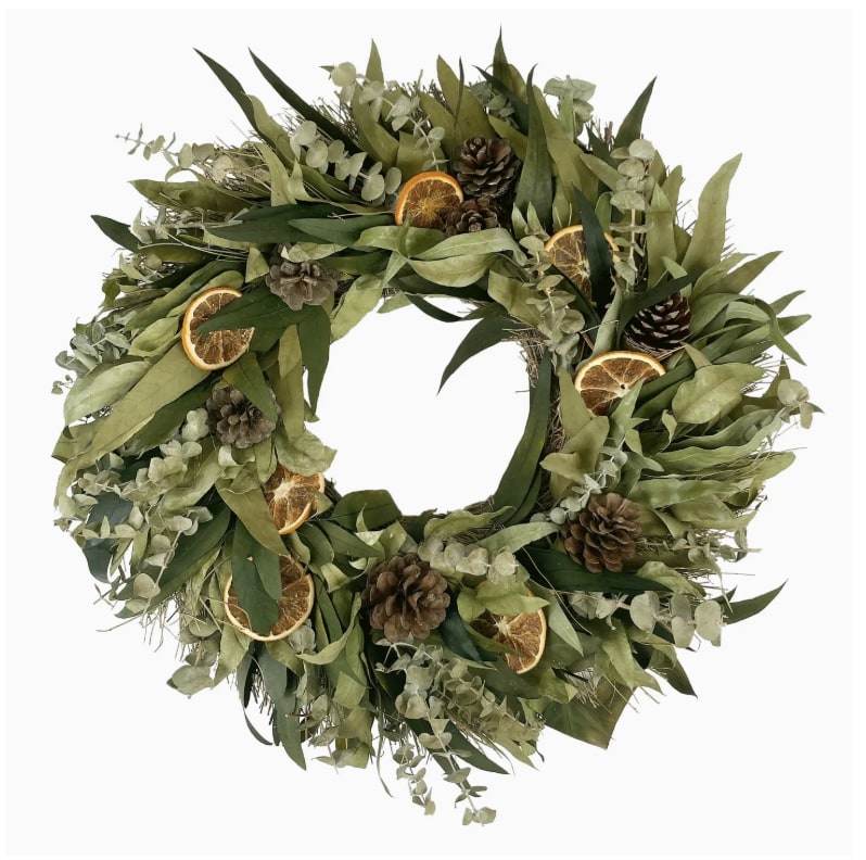 Citrus &amp; Eucalyptus Spice Wreath - A festive wreath that can both transition in and out of the holiday with its lush greenery, this wreath is made on a twig base with gorgeous baby and willow eucalyptus leaves and accentuated with natural pinecones and orange slices to fill the wreath out.  - 18" diameter - Each wreath comes in a wooden crate - Made with natural dried materials   - Please note that our wreaths are handmade of natural materials that can be damaged if exposed to rain, snow, or heavy wind. We recommend keeping our wreaths inside or on a covered  porch to protect the wreath.  Weight: 5 lb (2.27 kg)  Dimensions: 18 x 18 x 3.5 in (45.7 x 45.7 x 8.9 cm)