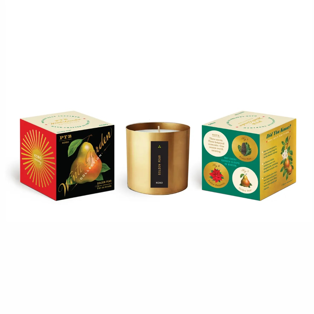 Three boxed candles, including a gold tin candle in the center