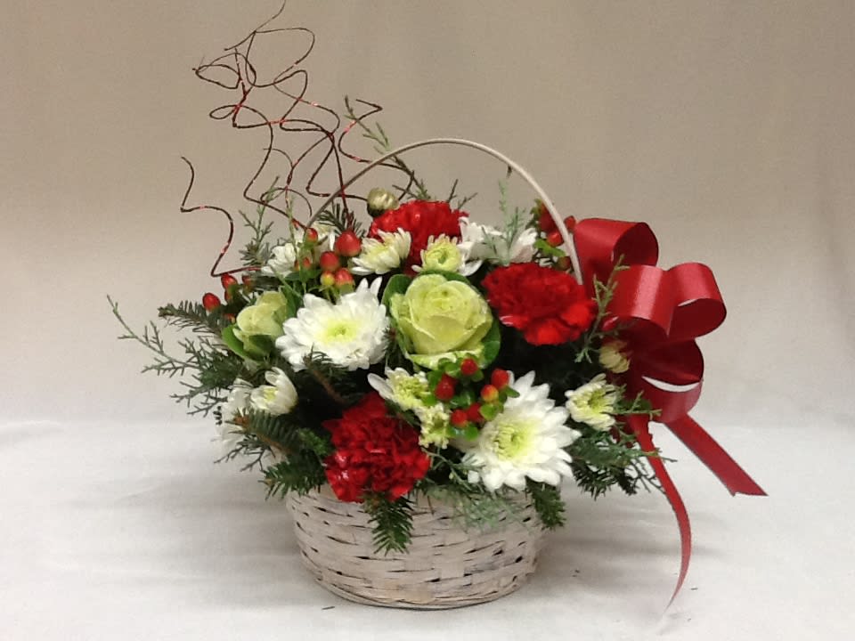Basket arrangement of red and white flowers with a red ribbon bow