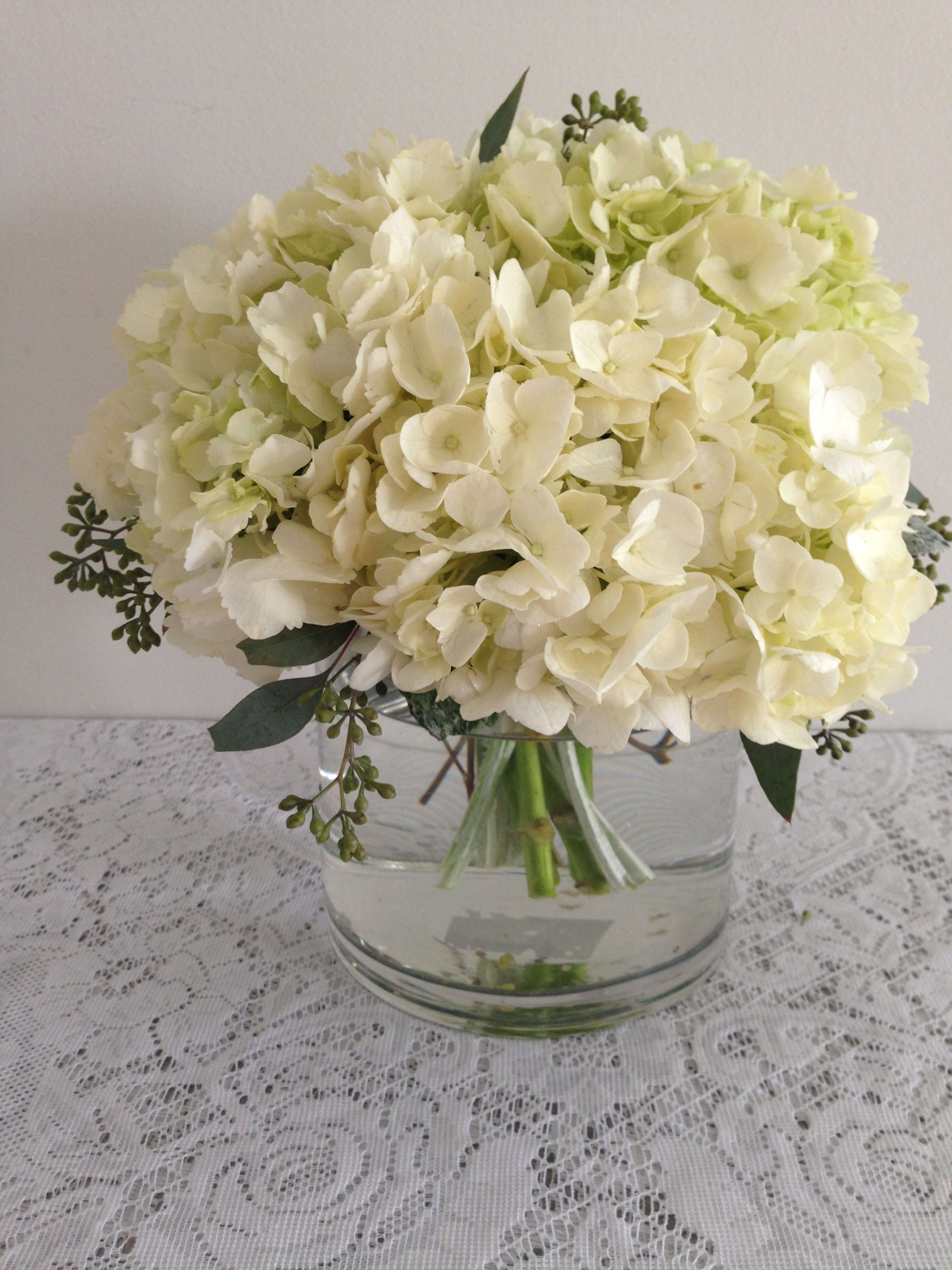 White hydrangea bouquet in a clear glass vase