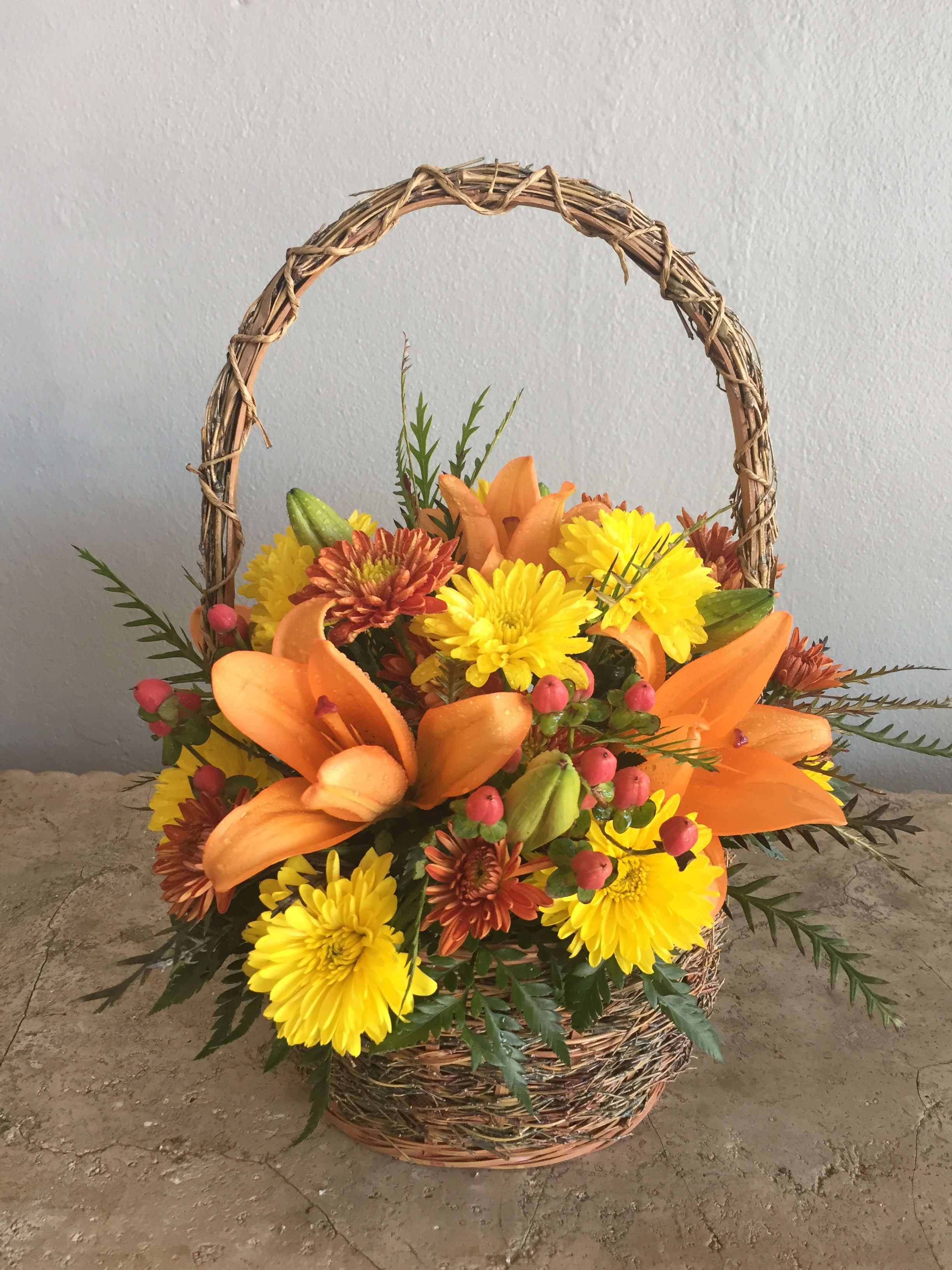 Basket arrangement with orange lilies and yellow chrysanthemums