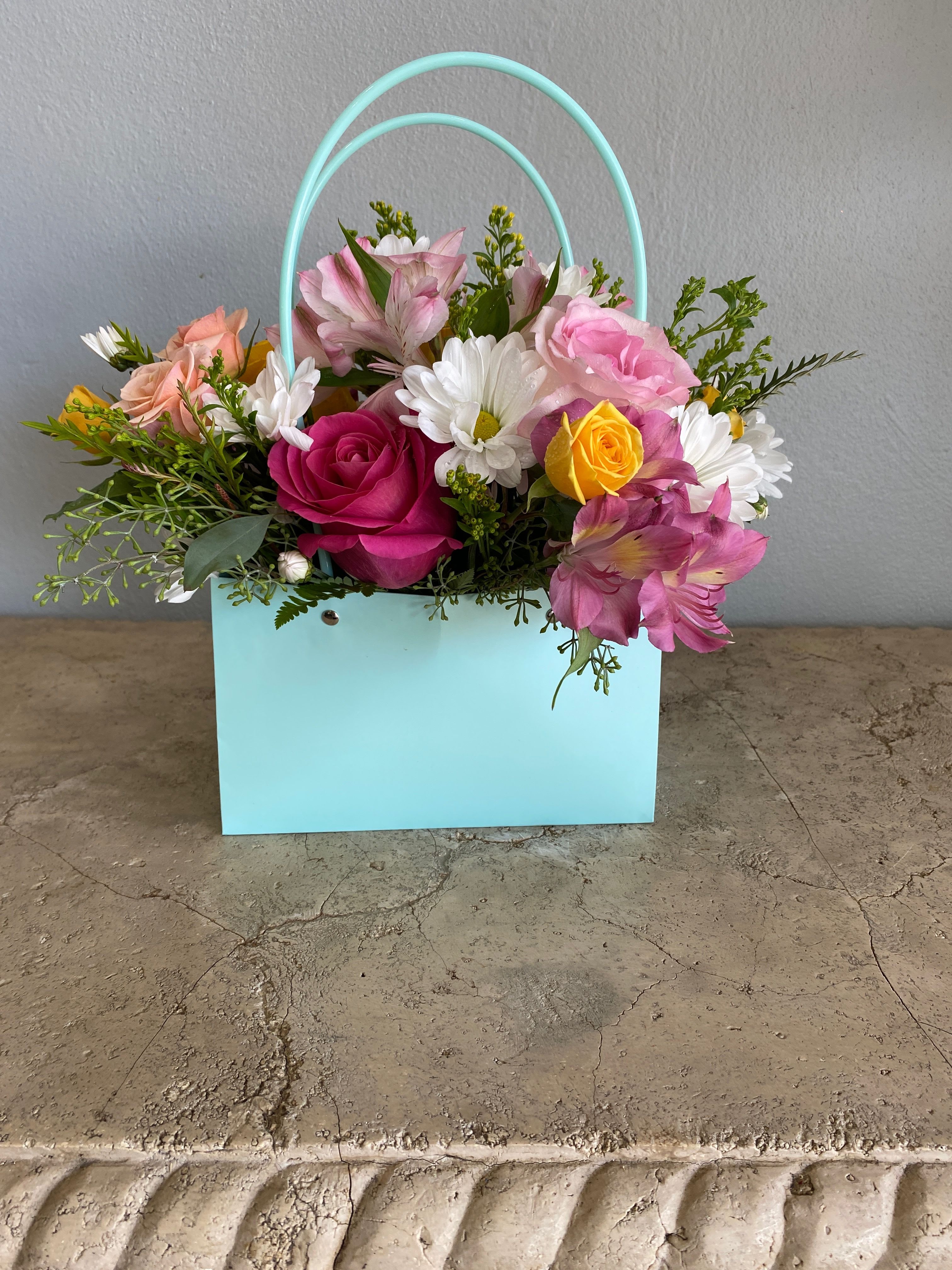 Hooray 2 - With vibrant colors like oranges, blues, yellows.. in a water proof bag. This gift is packed with Seasonal gorgeous blooms like roses, delphinium, daisies and lilies .Our talented designers will choose the freshest flowers available.  Color of bag may be different.   Available for pickup or delivery in West Palm Beach, Palm Beach, Lake Worth, Palm Beach Gardens and surrounding areas.