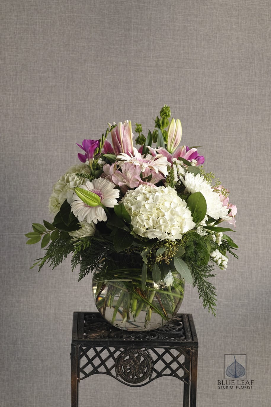 Mixed pink and white flower arrangement in a glass vase
