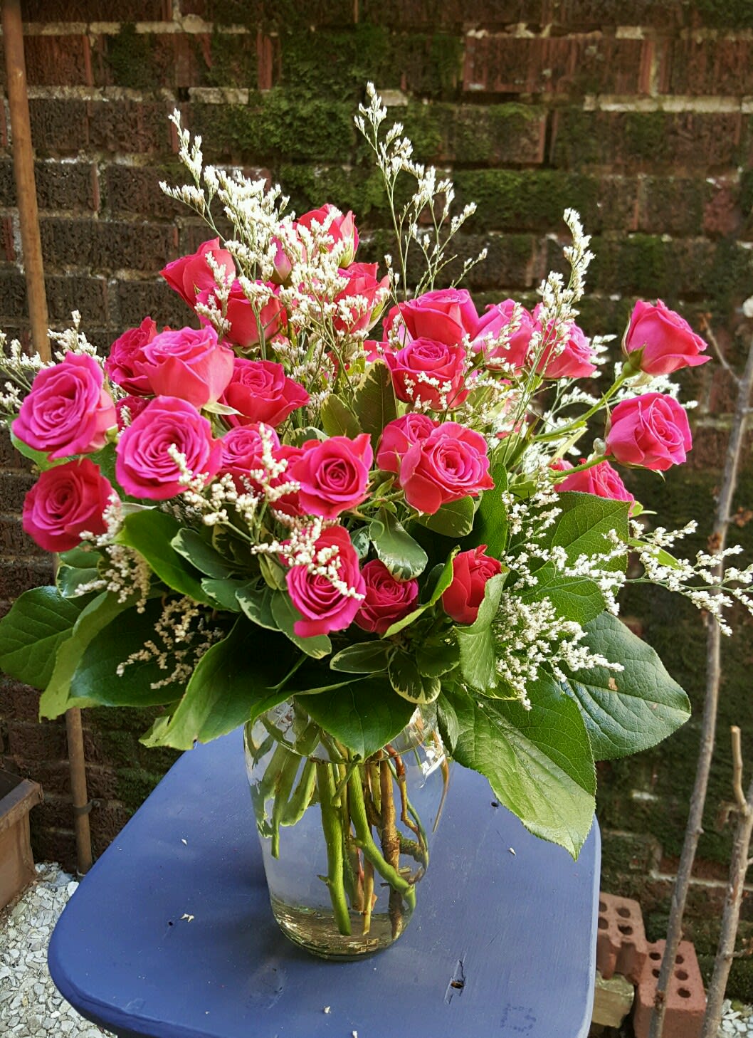 Lots of Spray Roses  - This vase is of dark pink spray roses. If you want another color of spray roses, such as white, light pink, orange, yellow or red spray roses, please indicate. This vase is with filler flowers and mixed greens.