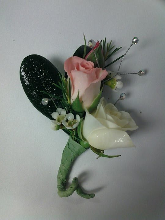 Spray Rose Bout - Pink &amp; white spray roses with some greens and wax flower. We will be happy to change colors of spray roses and use other greens &amp; fillers. Just call and talk with us.