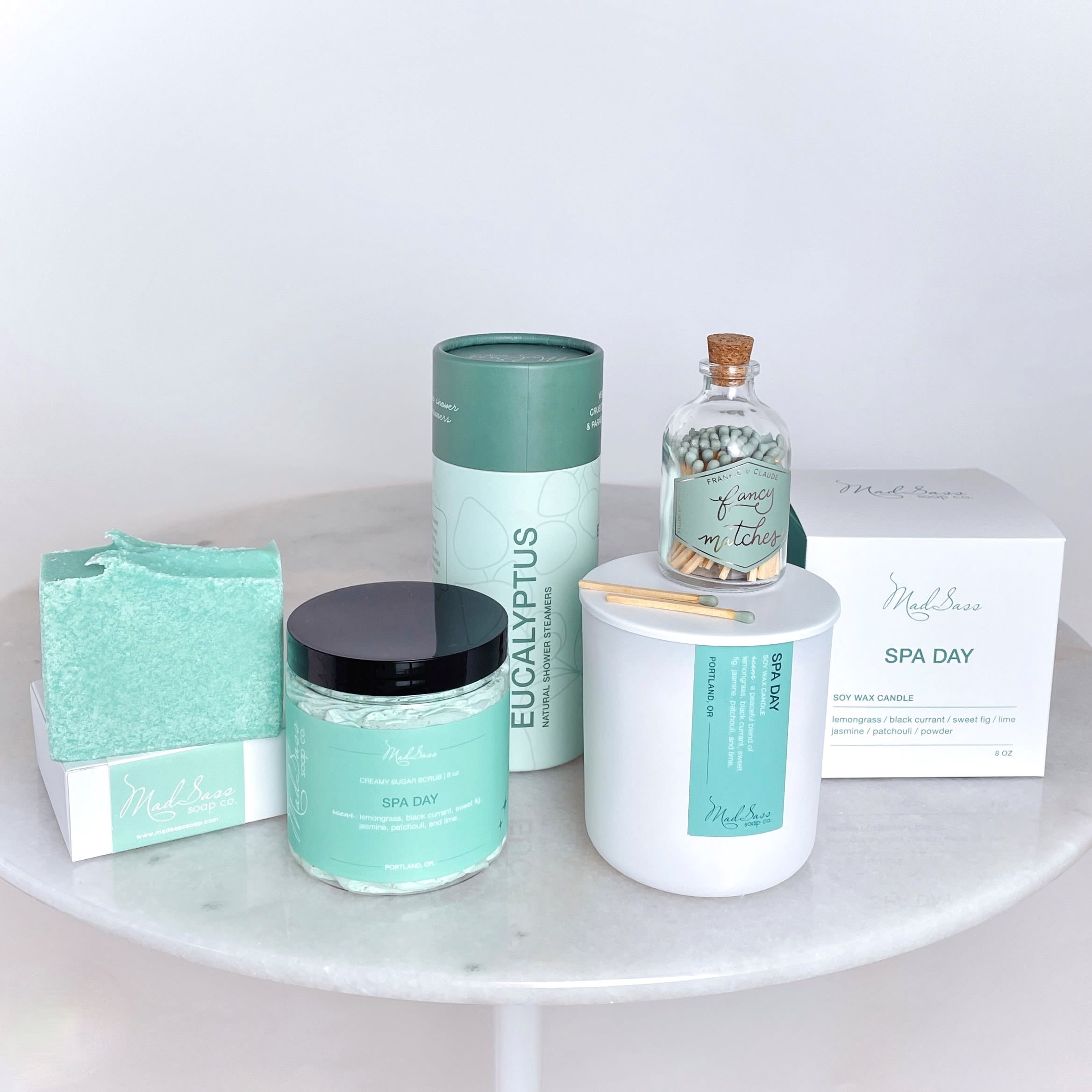 Spa gift set with candles, soap, matches, and bath items in mint packaging