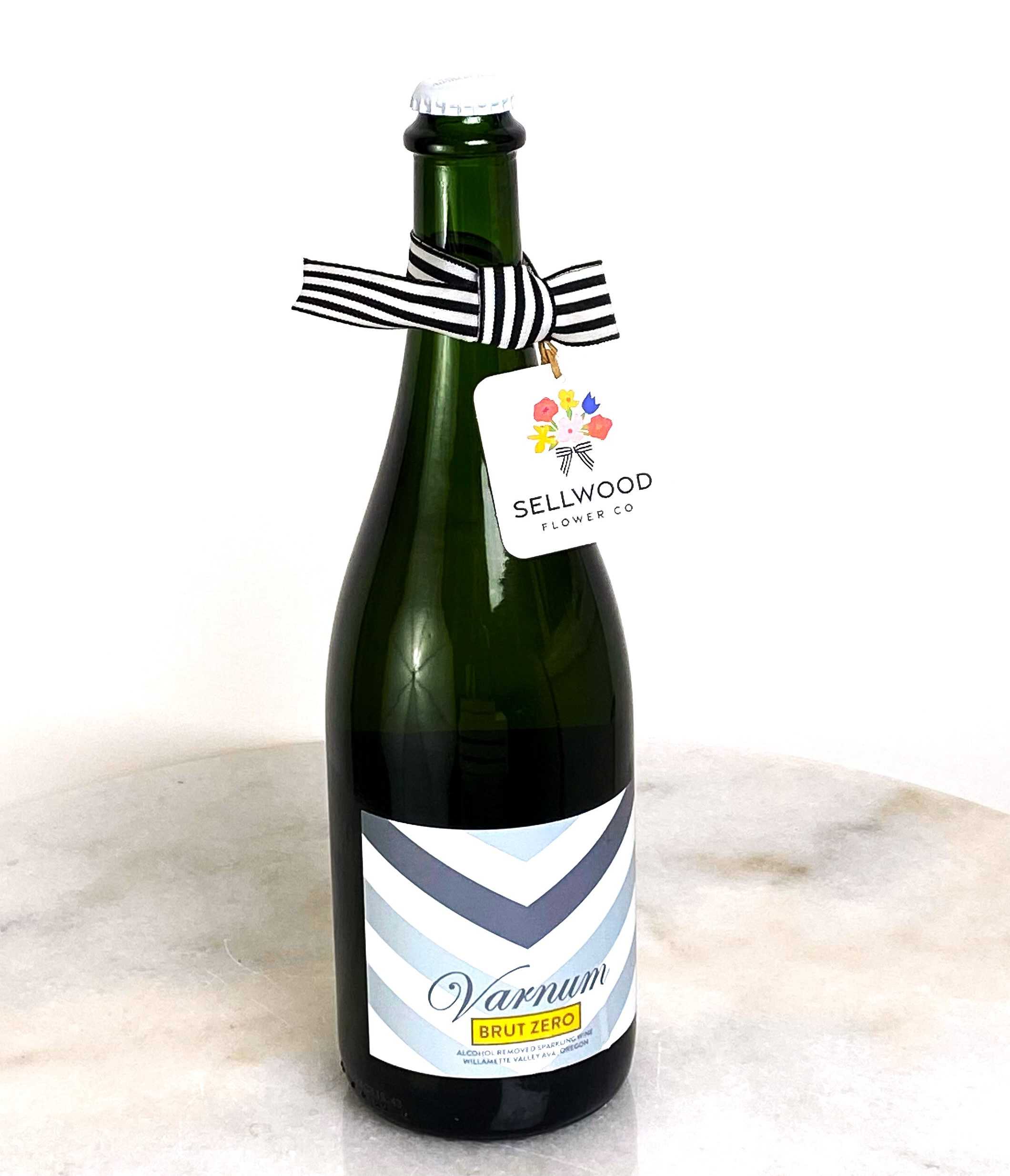 Bottle of sparkling wine with a striped ribbon and hanging tag