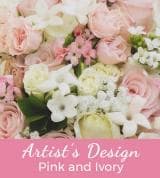 Pink and white roses arranged in a floral display