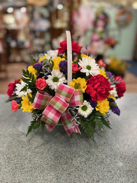 Basket of mixed daisies and carnations with a plaid bow
