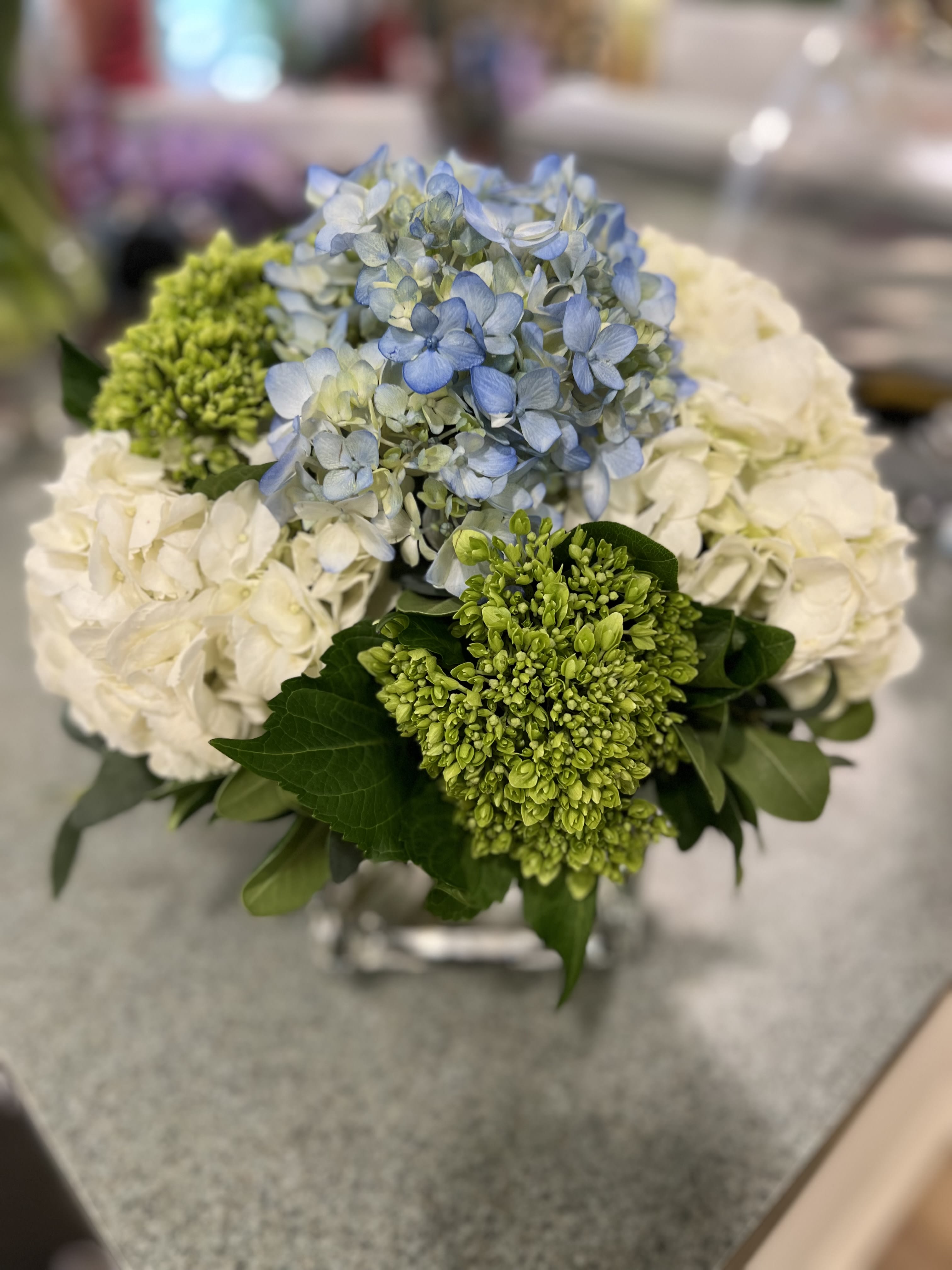 Blue and white hydrangea bouquet with green blooms