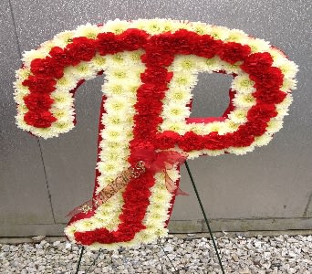 Red and white floral letter P on a stand